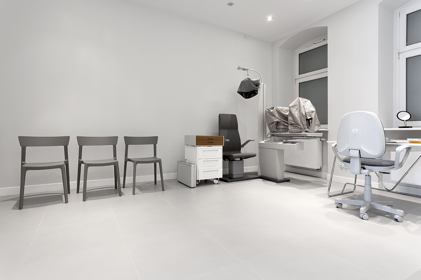 Light, large-format tiles in a modern, minimalist space.
