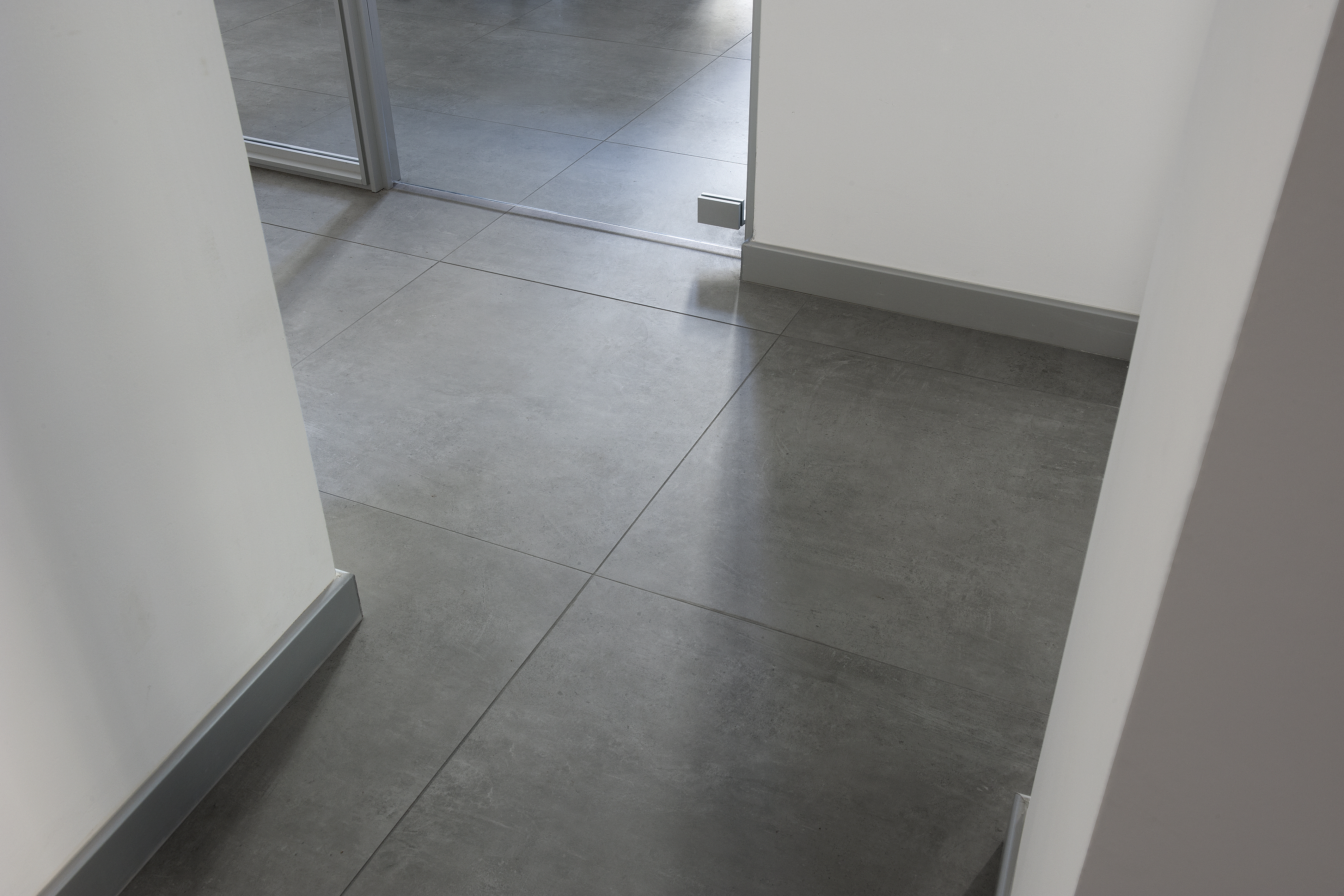 Grey, large-format indoor porcelain stoneware tiles with a modern concrete look.