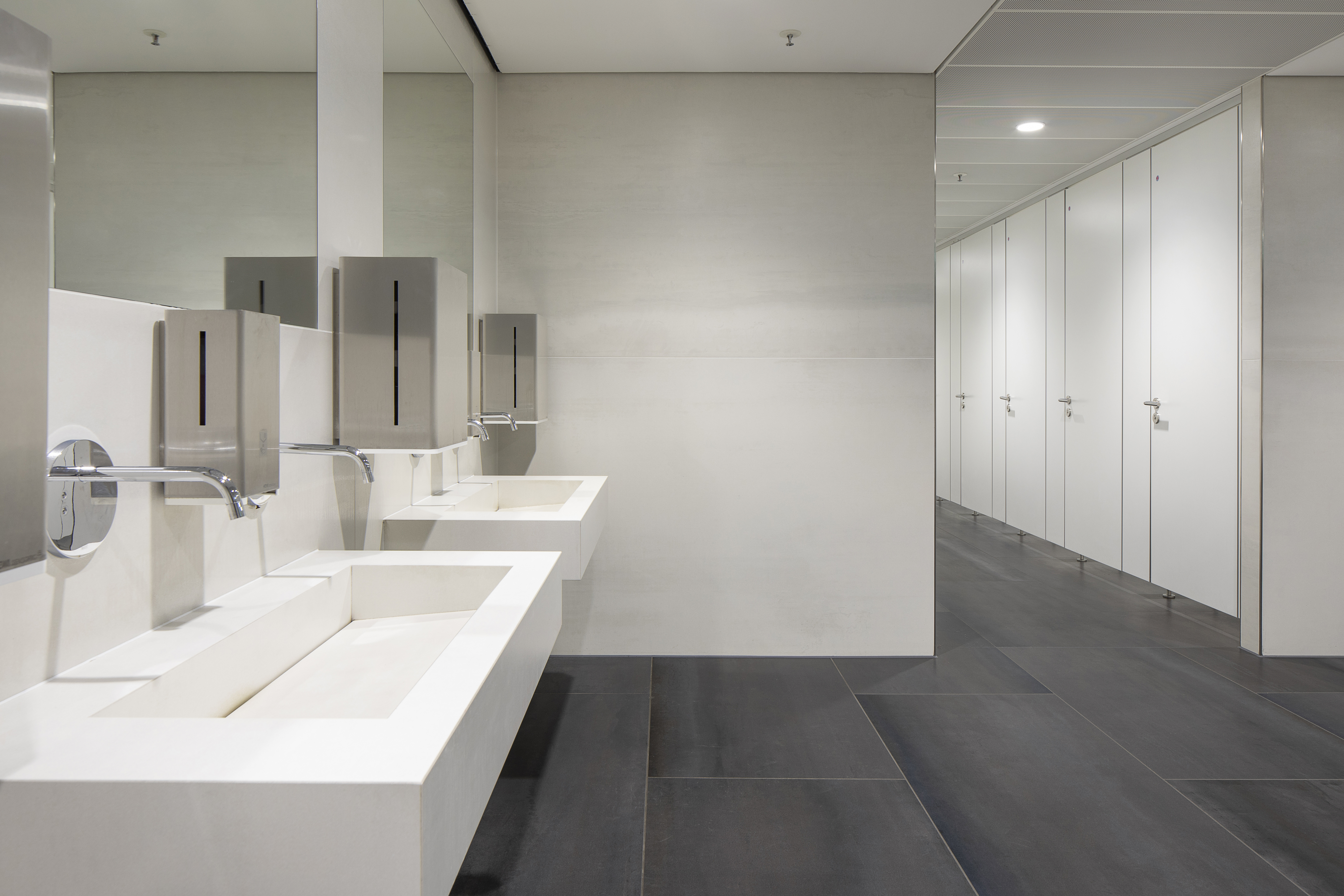 Dark grey large-format floor tiles in a modern bathroom.