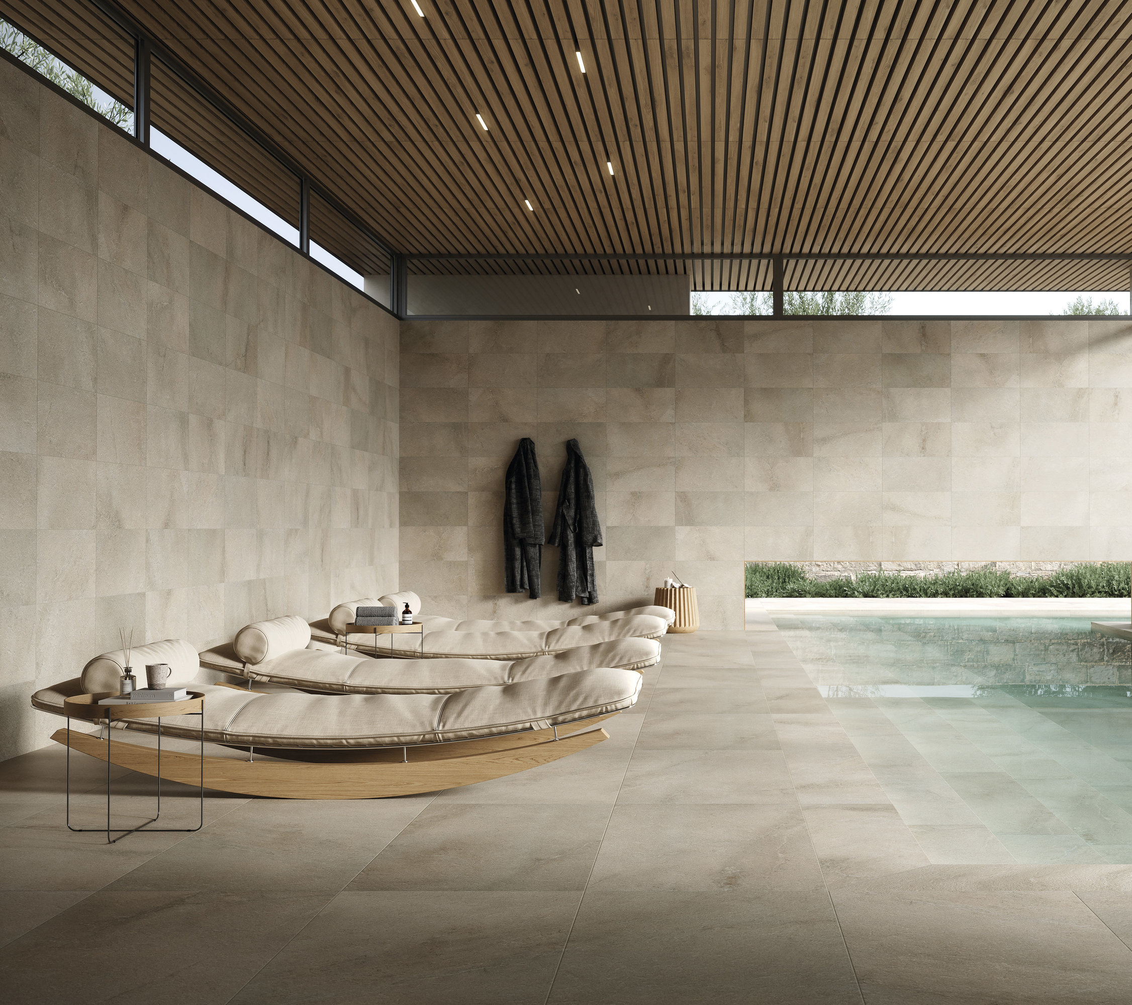Exclusive wellness area with light porcelain tiles on floor and walls, pool, and loungers.