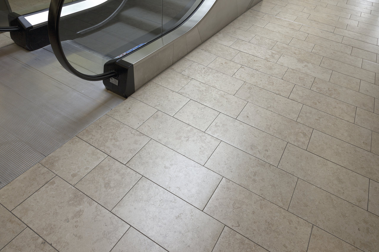 Light rectangular floor tiles, perfect for high-traffic indoor use.