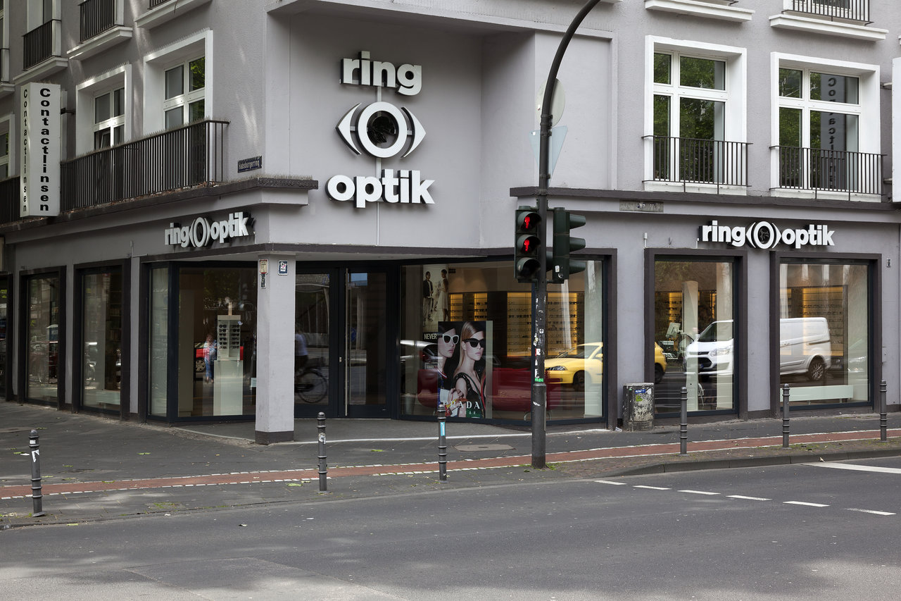 Exterior view of Ring Optik optician's shop on a street corner.