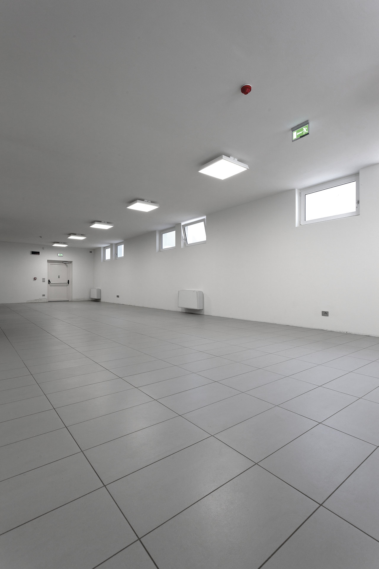 High-quality grey floor tiles in a bright, modern room.