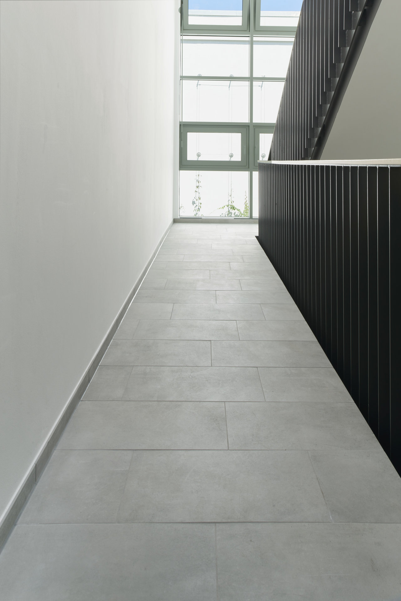 Modern, light grey hallway tiles, perfect for stylish interiors.