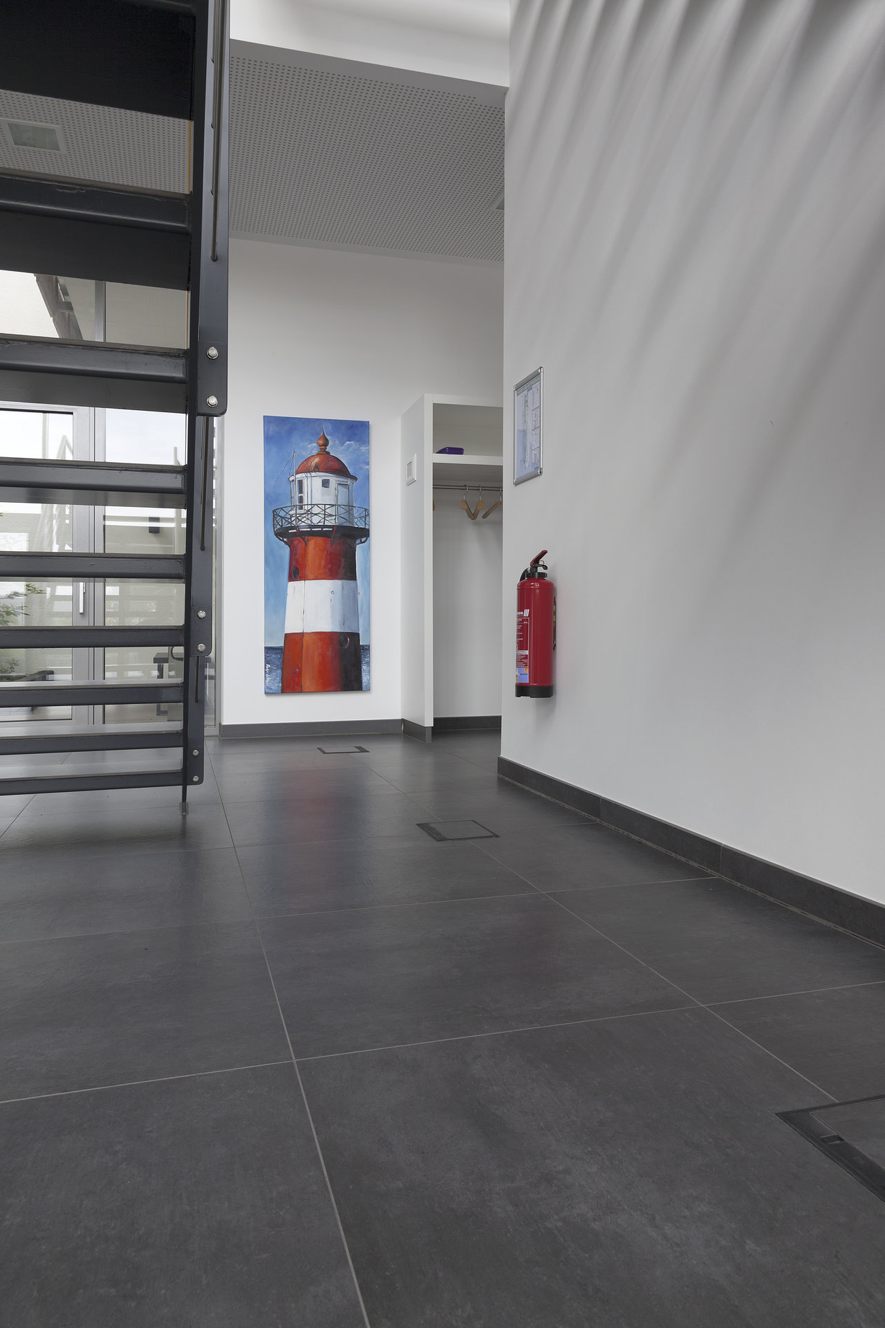 Large-format, dark grey tiles in a modern office environment.