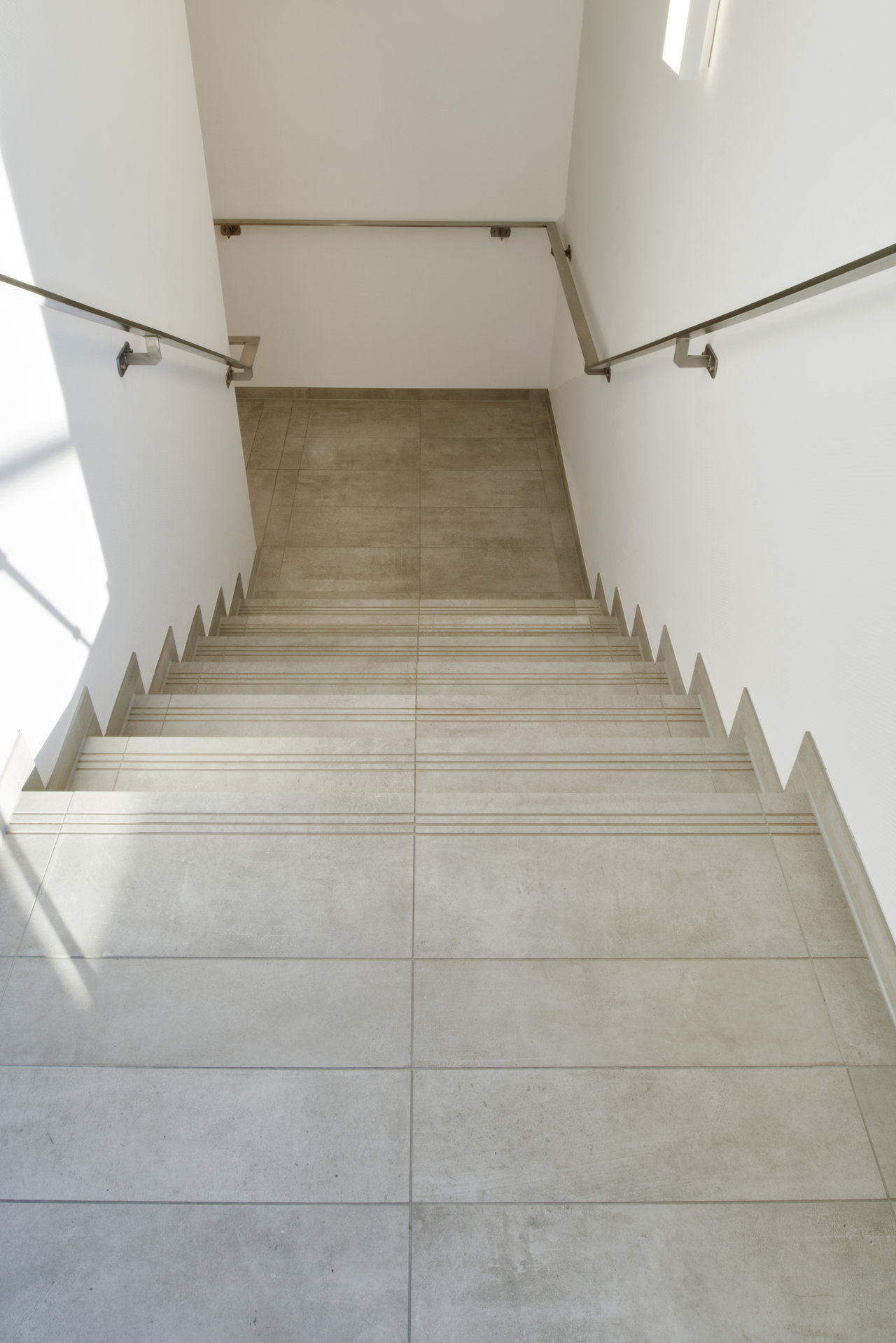 Premium modern concrete-look stair tiles for stylish interiors.