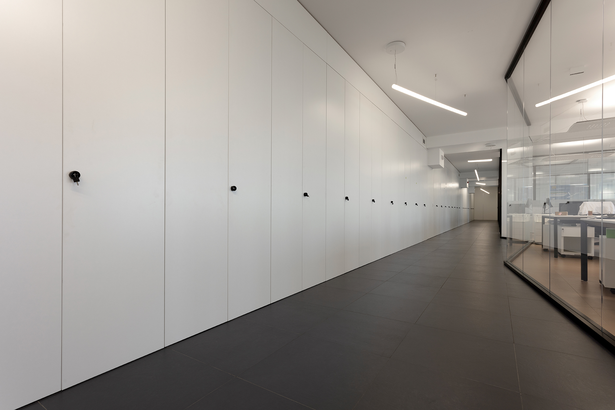 Dark floor tiles in the modern office hallway.