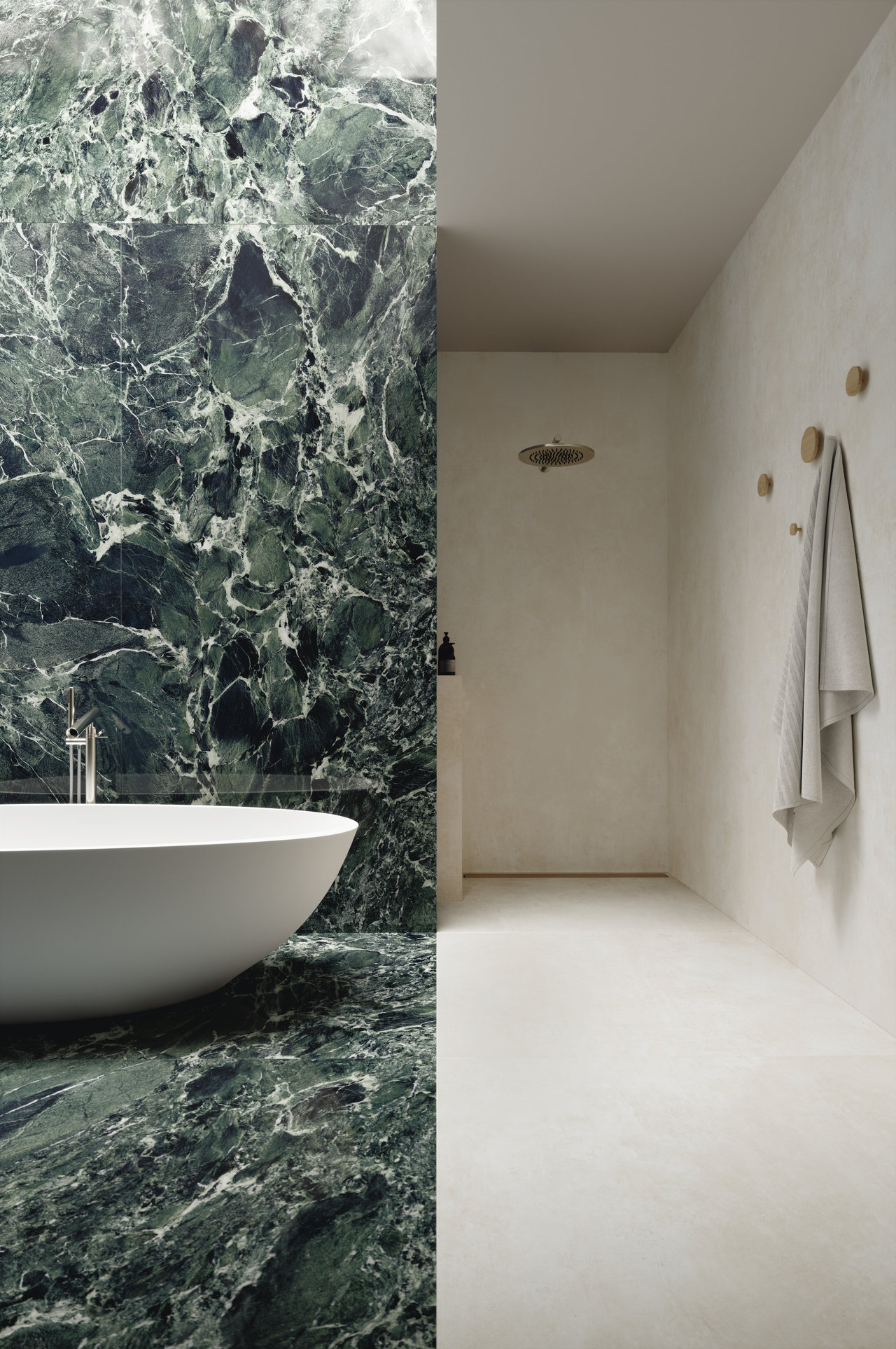 High-quality green marble tiles in a bathroom with a freestanding bathtub and bright shower area.