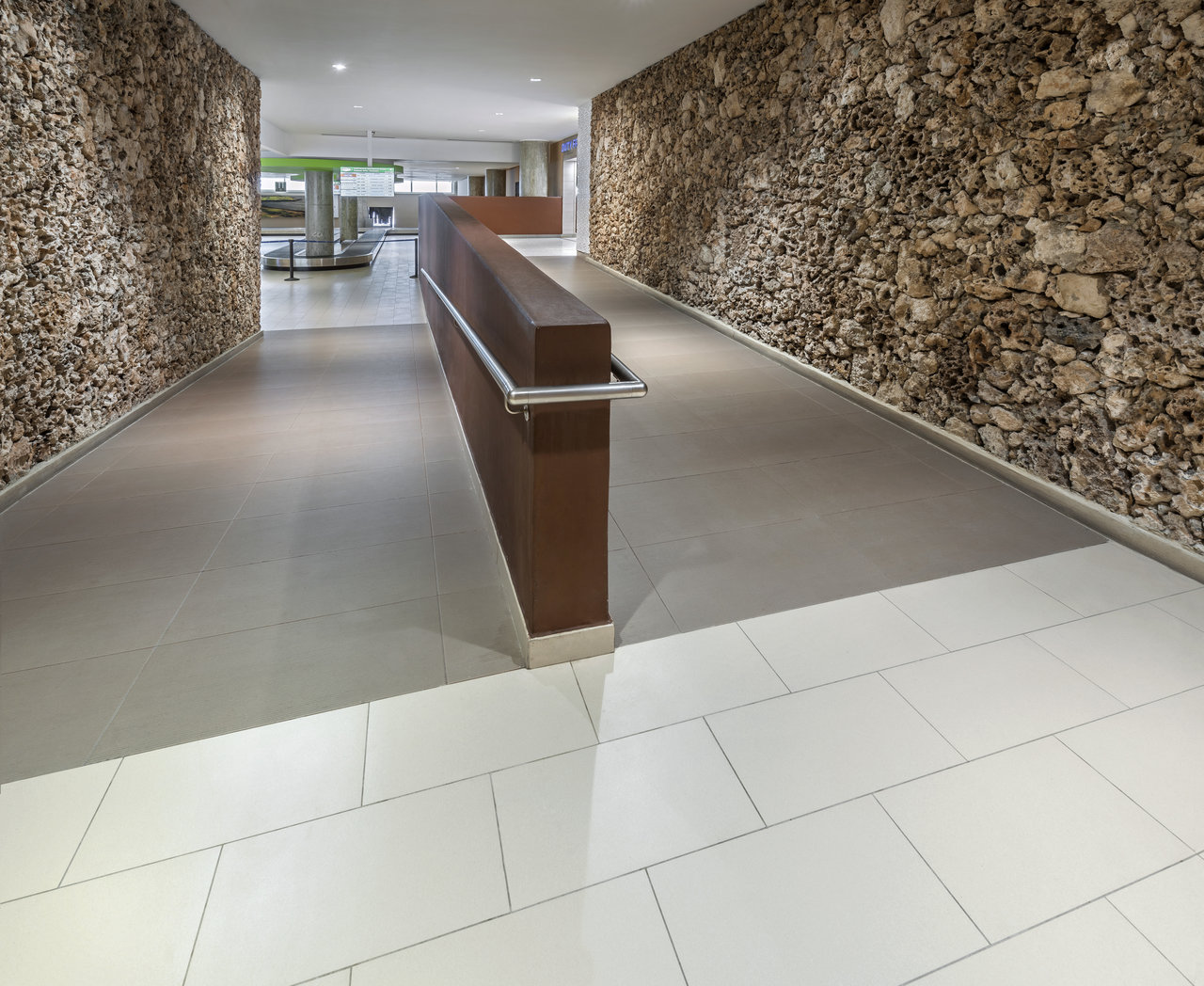 Premium grey & white tiles in modern interior, stone wall details.