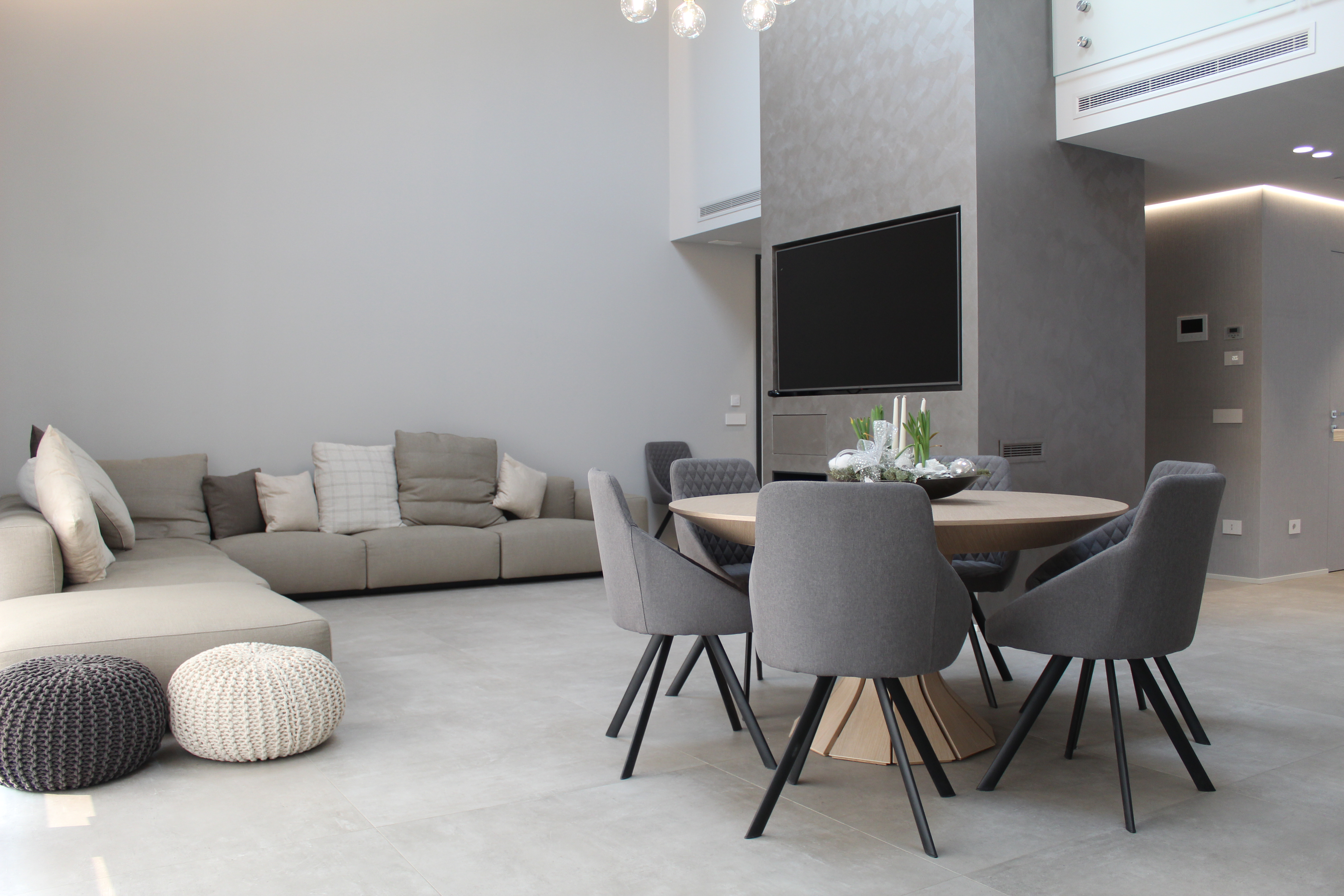 Bright, large-format floor tiles in a modern living and dining area.