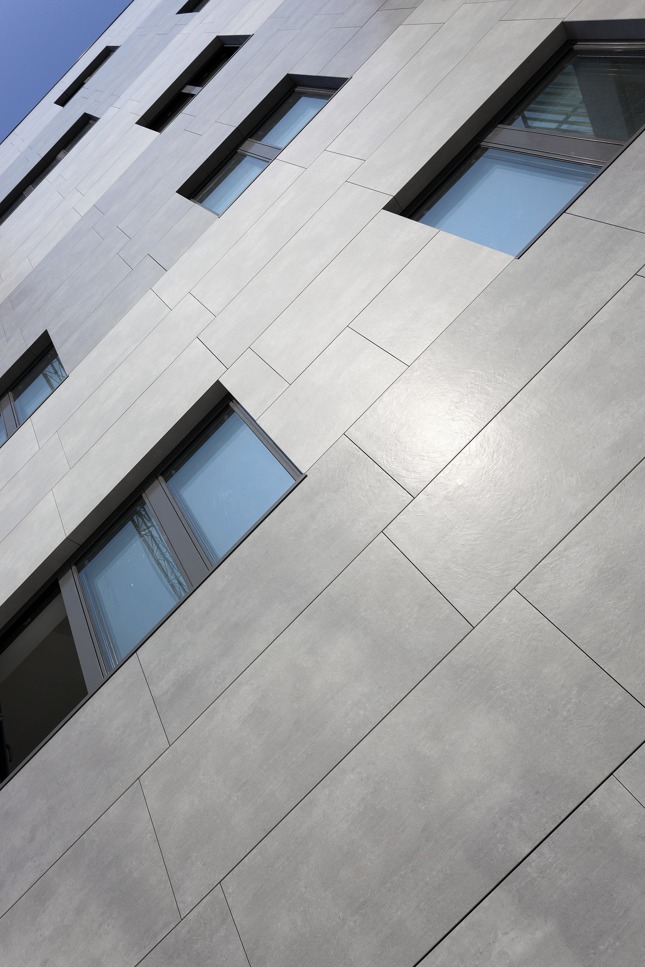 Modern building facade with grey outdoor tiles by Porcelaingres.