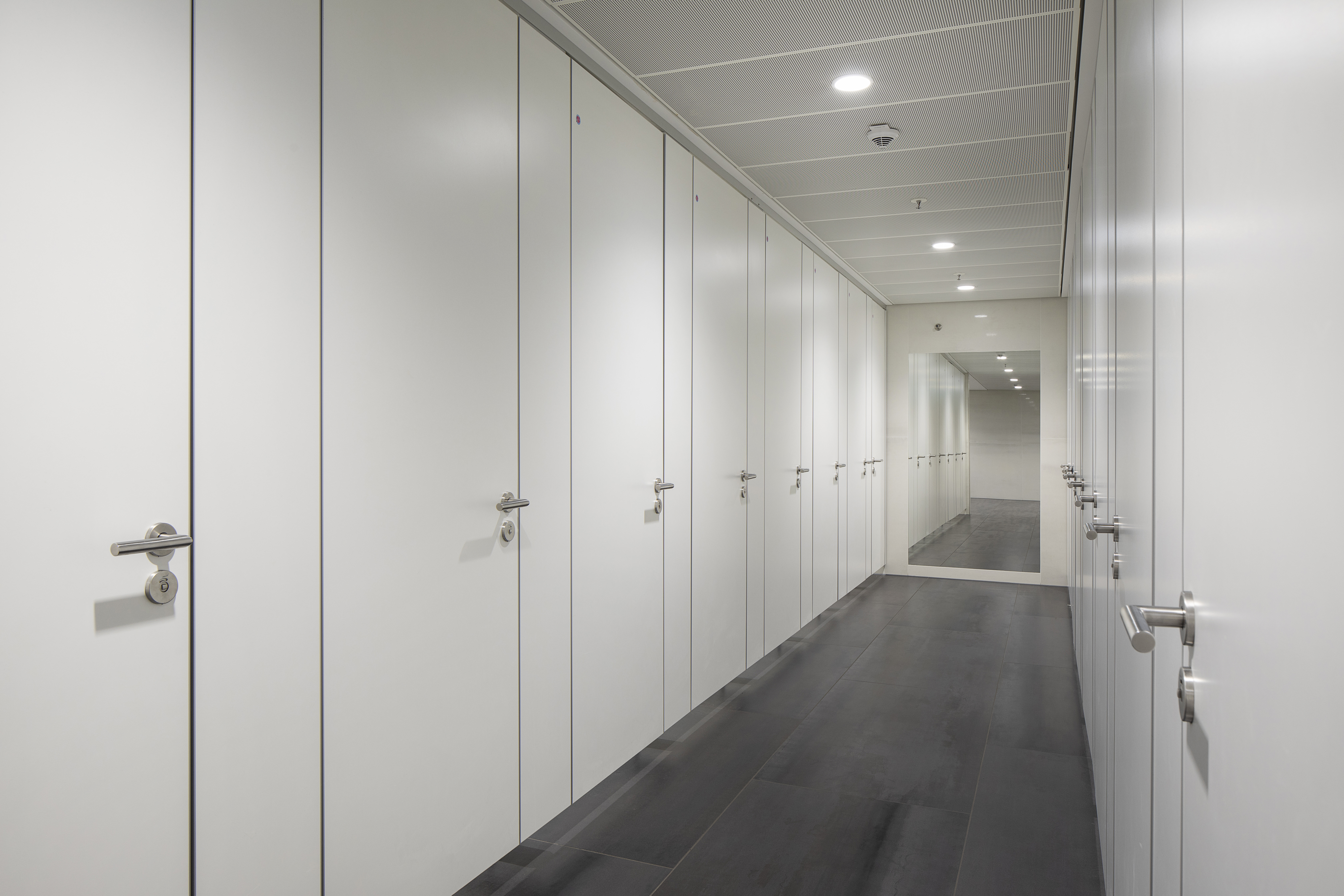 High-quality, dark tiles in the hallway of a modern building.