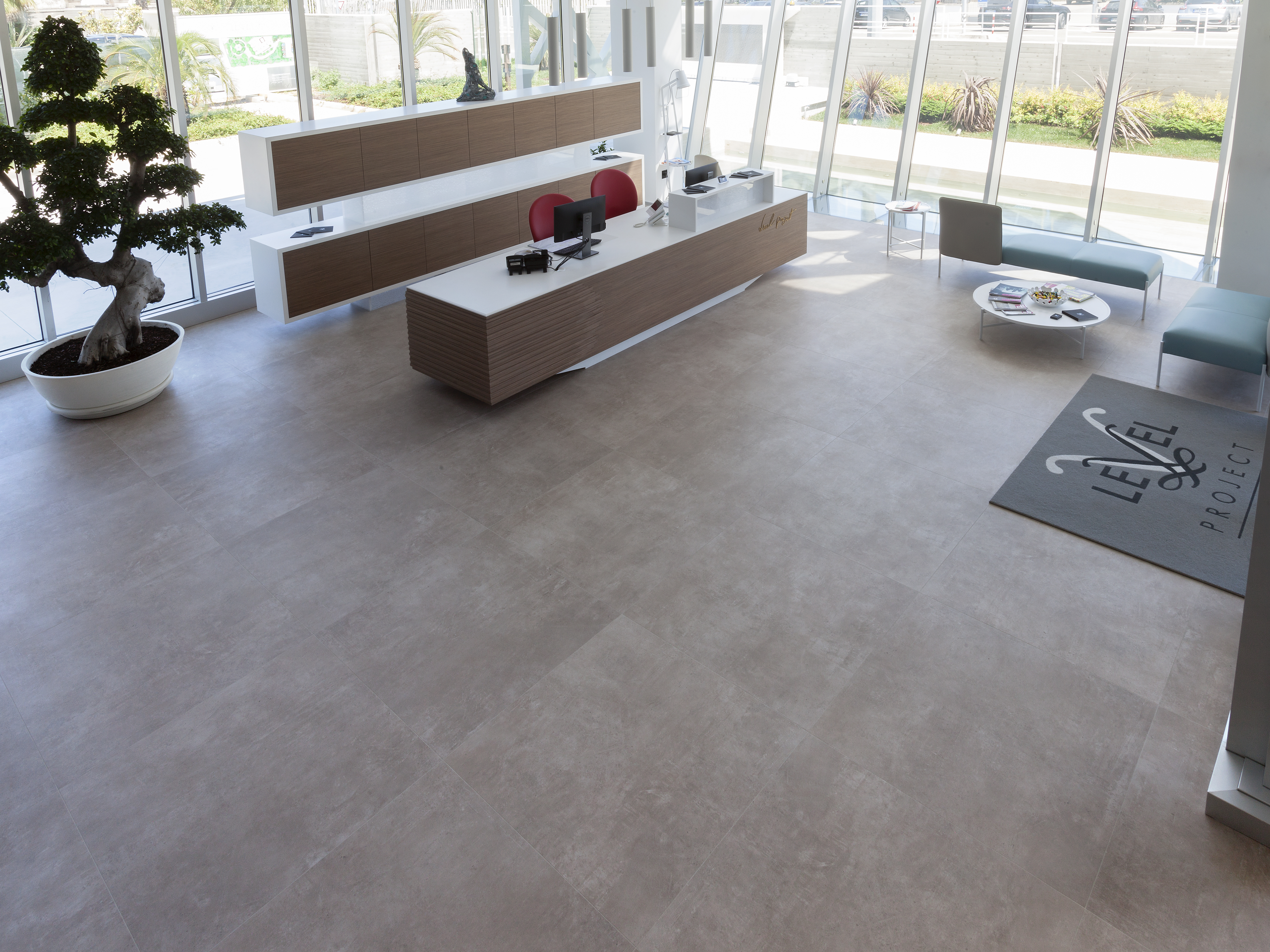 Large, light porcelain tiles in a modern reception area.