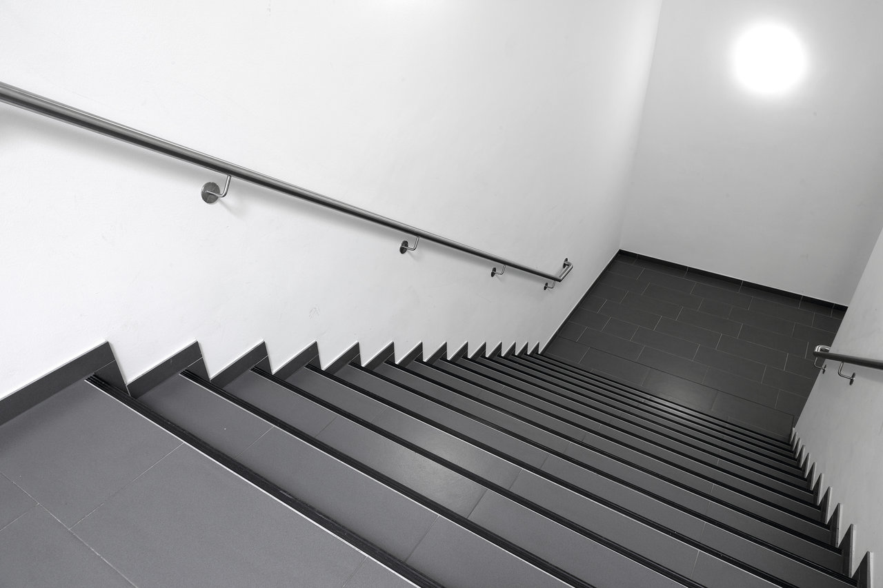 Modern staircase with anthracite tiles and simple design.