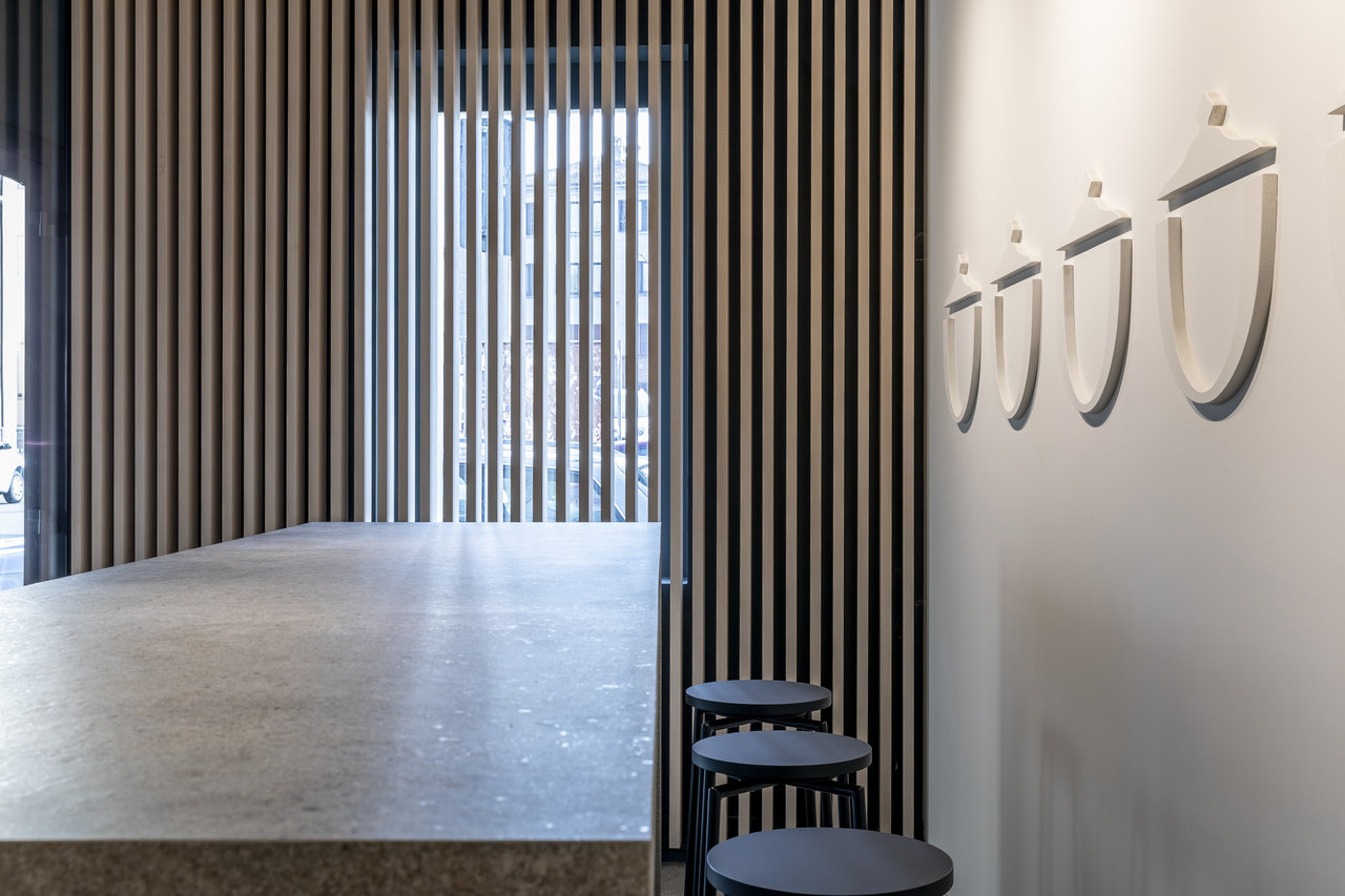 Modern room with light concrete-look tile floor and vertical wooden slats on the wall.