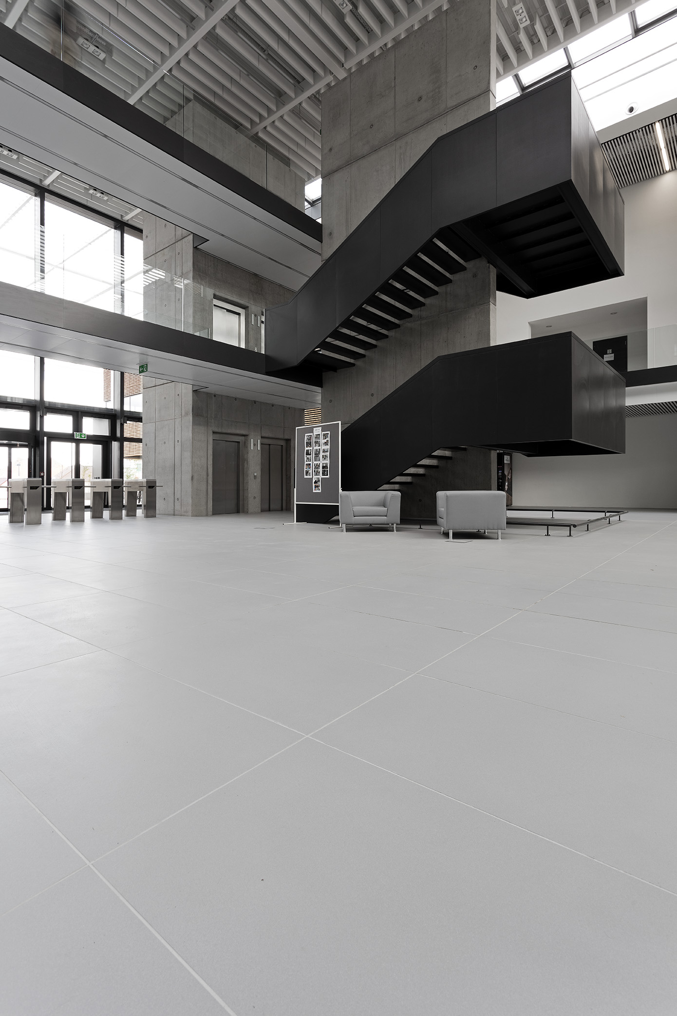 Bright, large-format floor tiles in a modern, minimalist reception area.