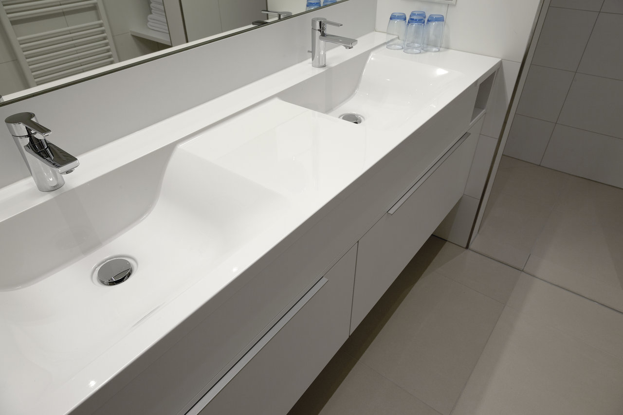 High-quality floor tiles in a modern bathroom with a double vanity and mirror.