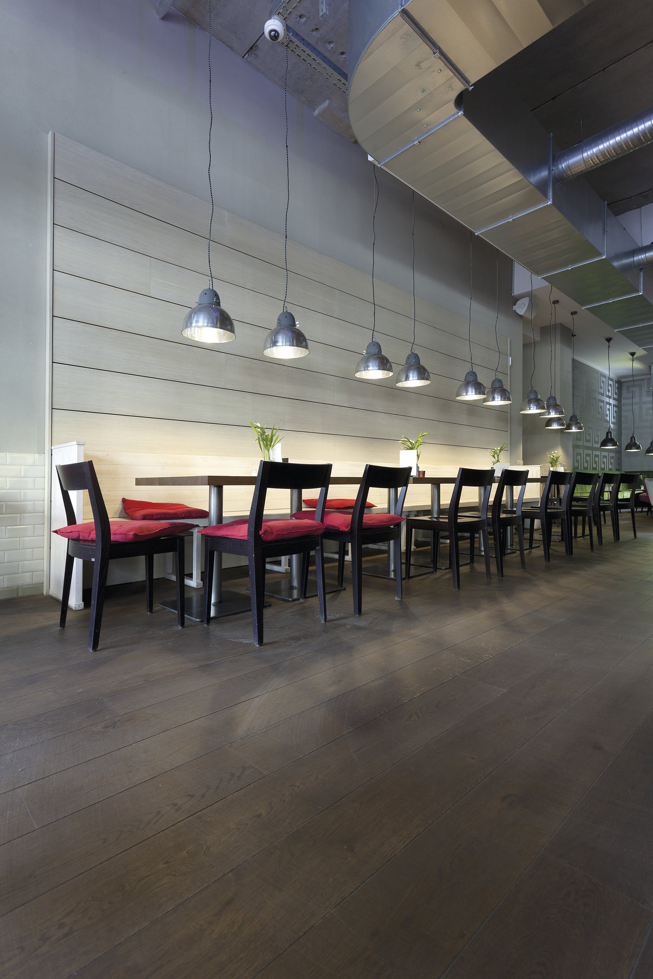 Stylish interior with dark wood-look tile floor and modern seating.