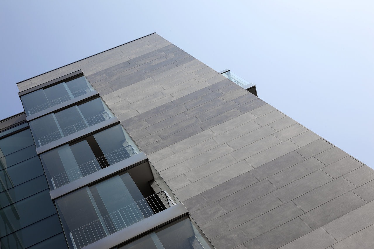 Modern facade with large-format grey striped tiles.