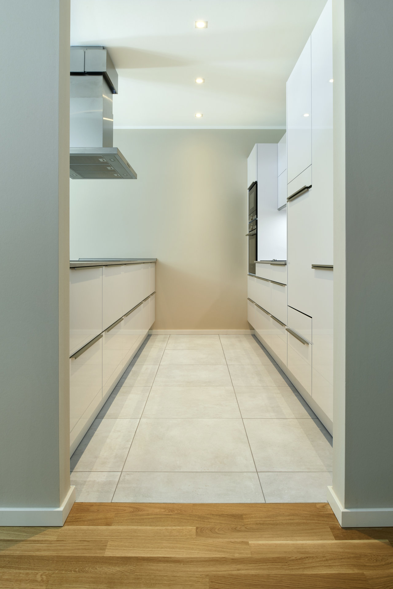 Light large-format indoor tiles in a modern kitchen.