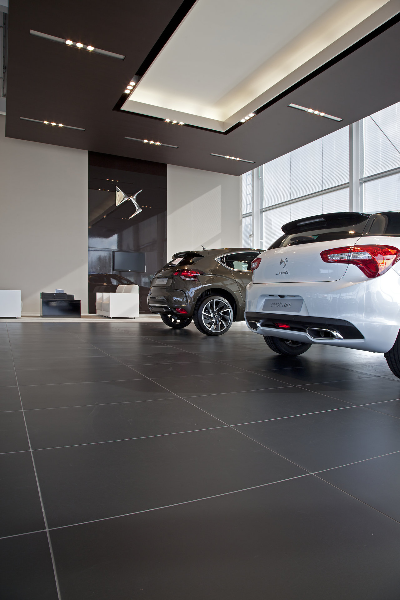 High-quality, large-format dark tiles with light grout in a modern showroom.