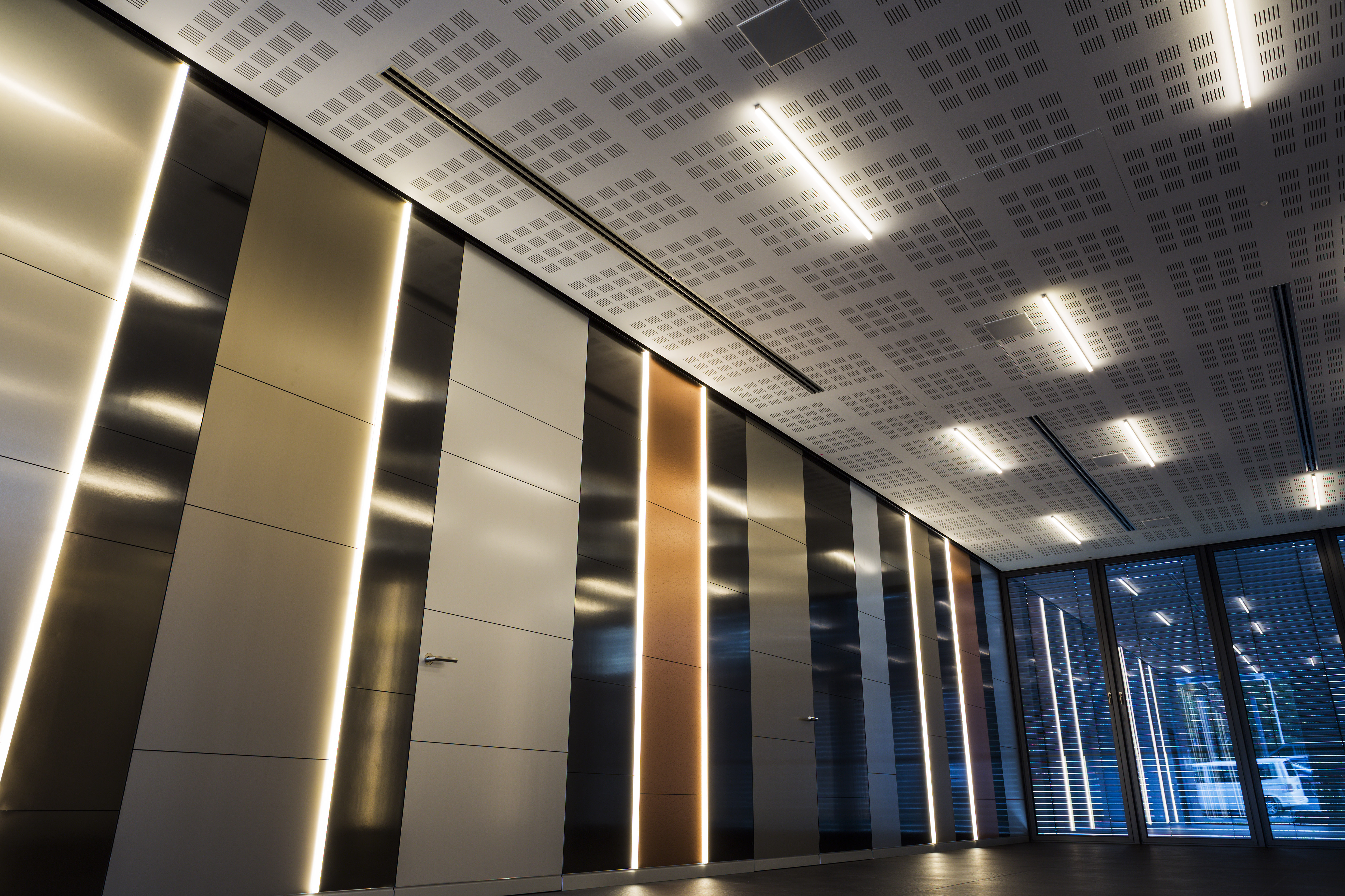 Modern wall design with vertical metal-effect panels and integrated LED lighting.