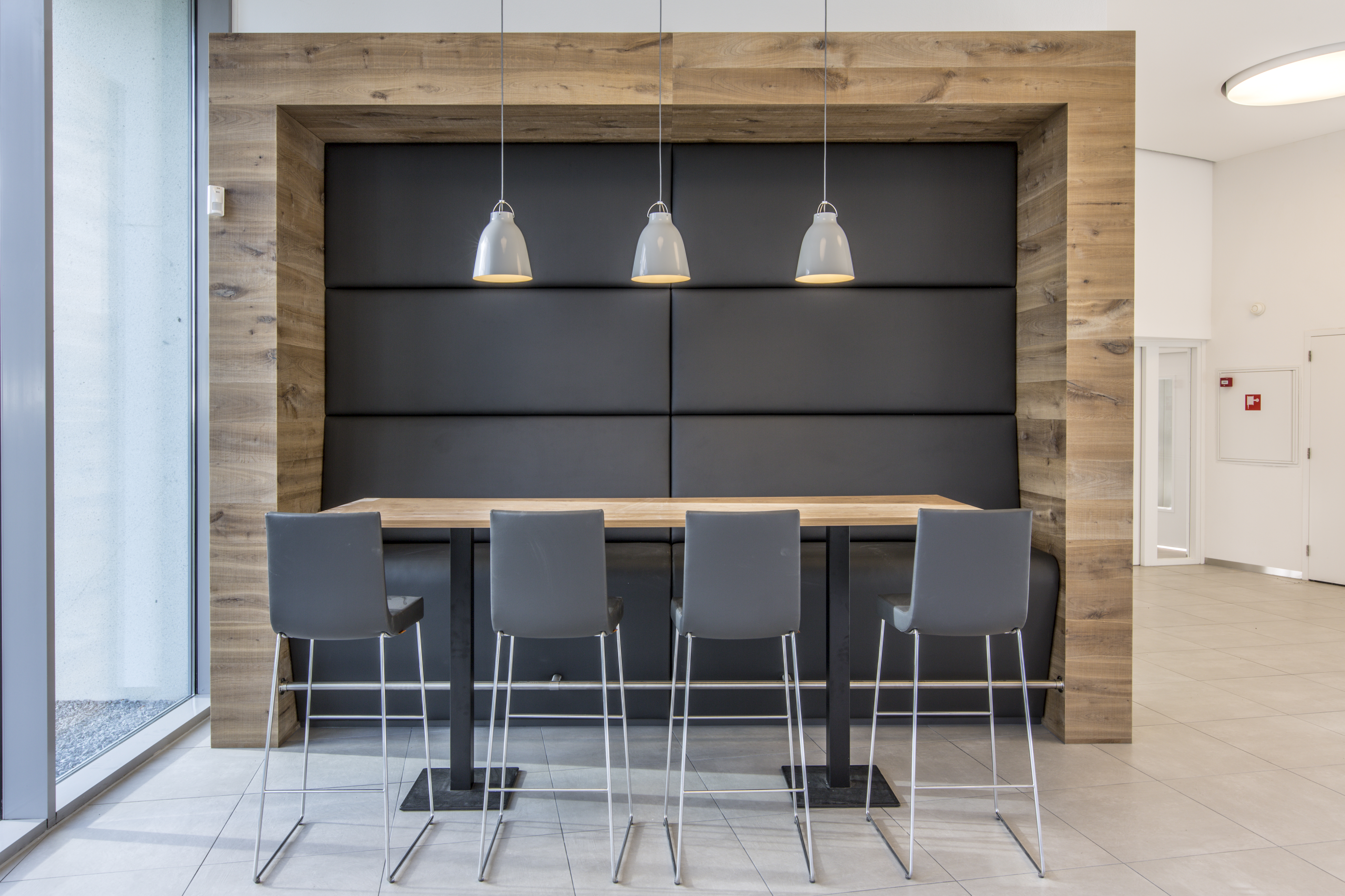 Light floor tiles in modern lounge with wood accents.