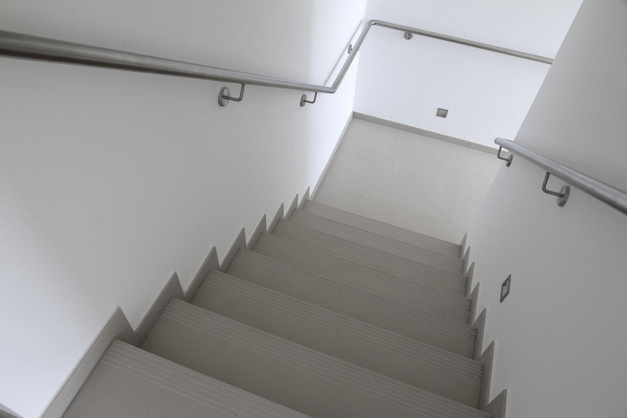 Modern staircase with light grey tile steps.