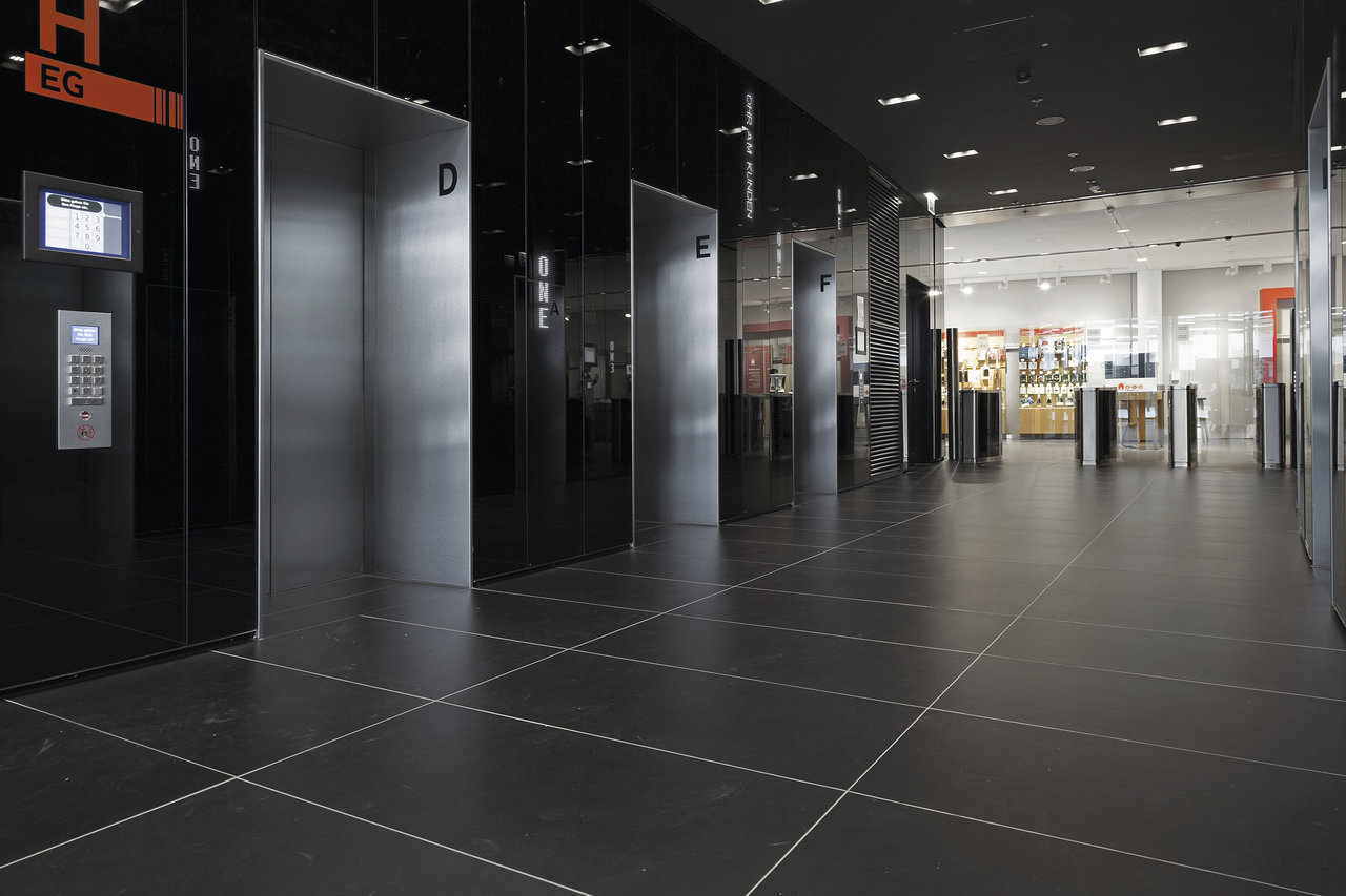 High-quality, dark tiles with light grout in a modern lift lobby.