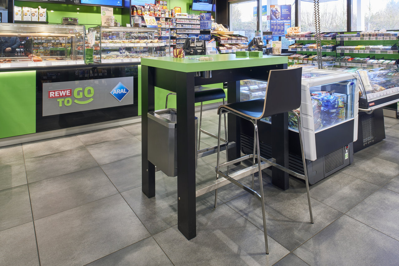 Large-format grey tiles in a modern shop interior.