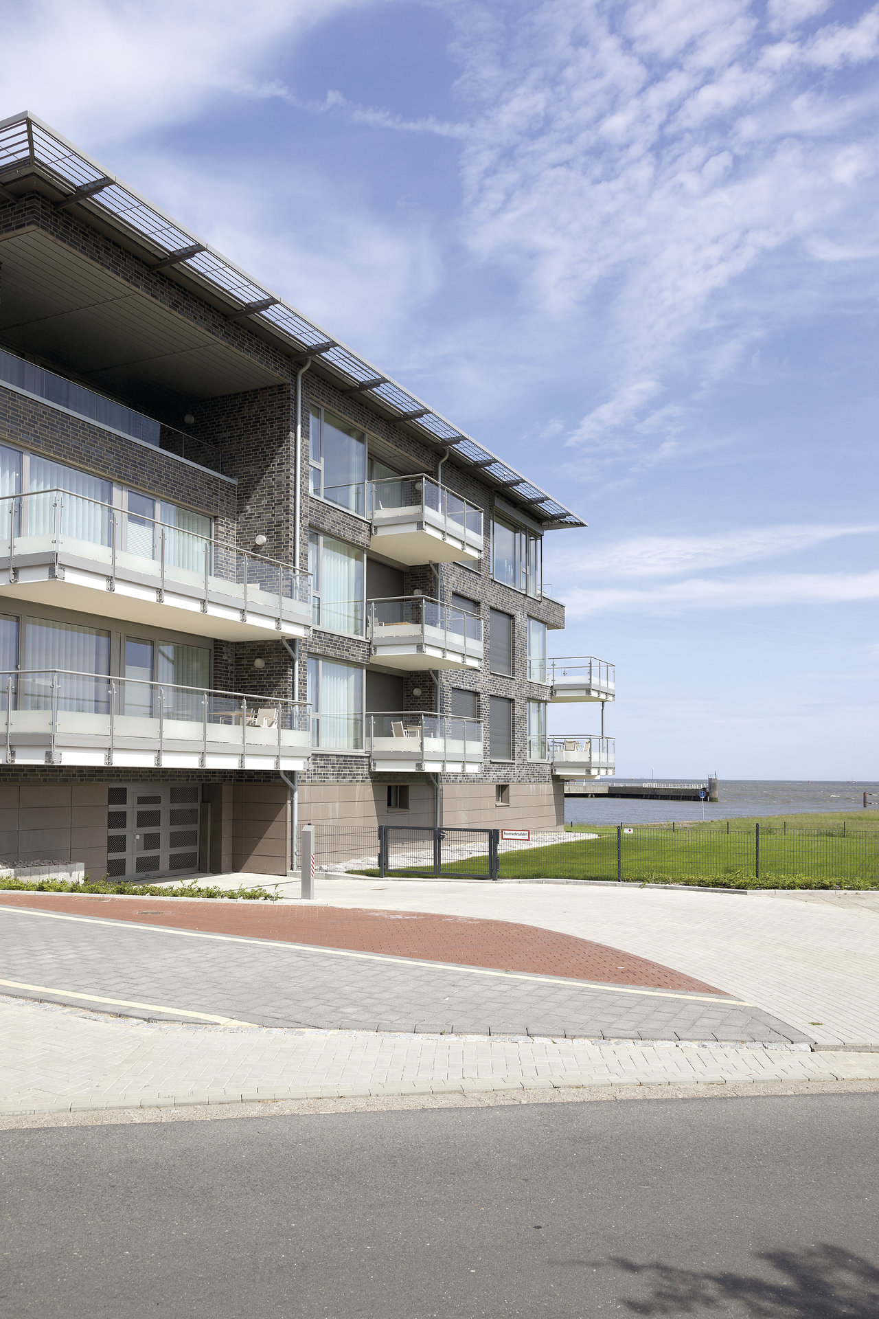 Modern waterfront home with premium outdoor paving.