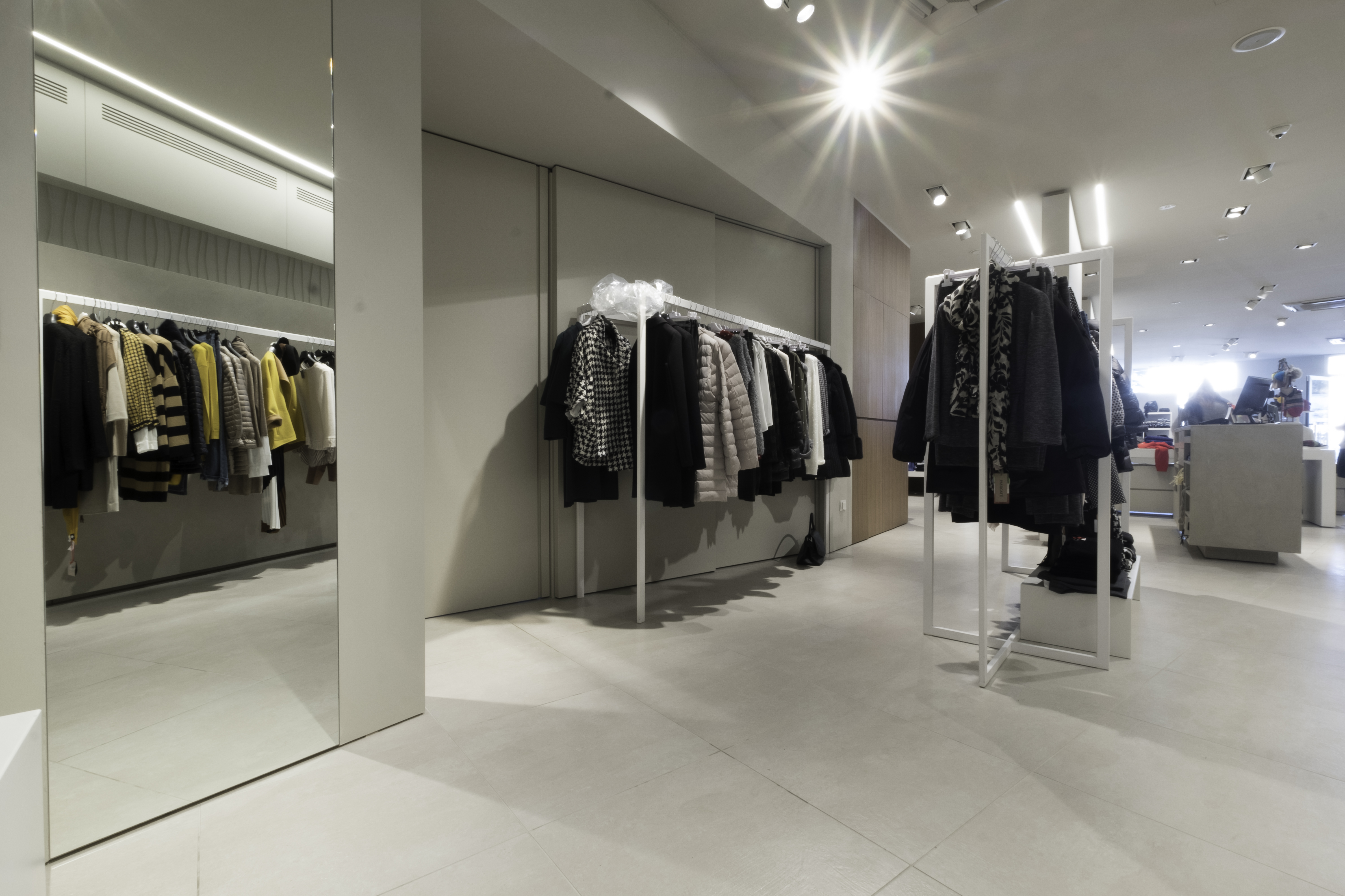 Large-format, light grey tiled floor in a modern shop, ideal for indoor use.
