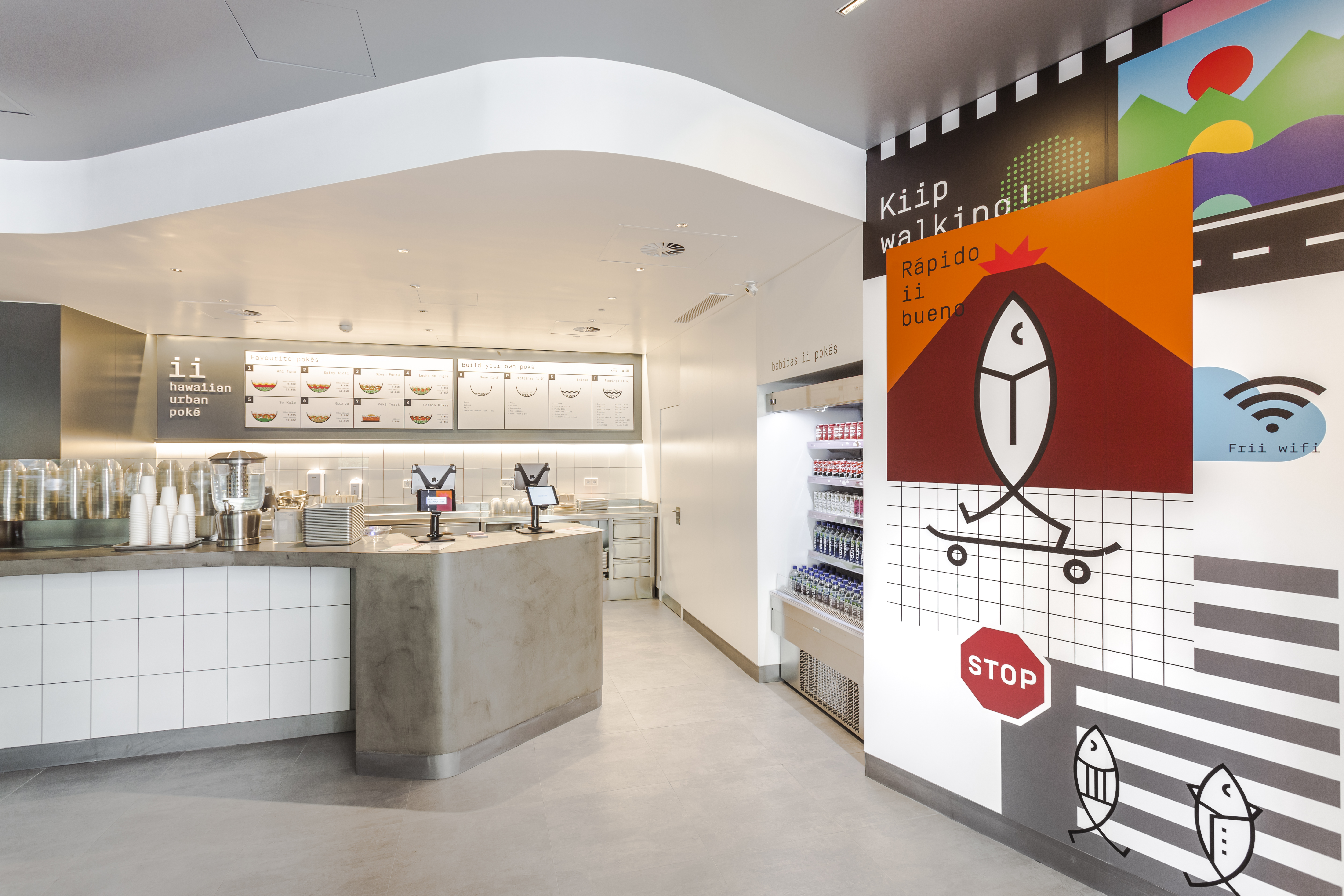 Modern café interior with light grey floor tiles and a white tiled counter.