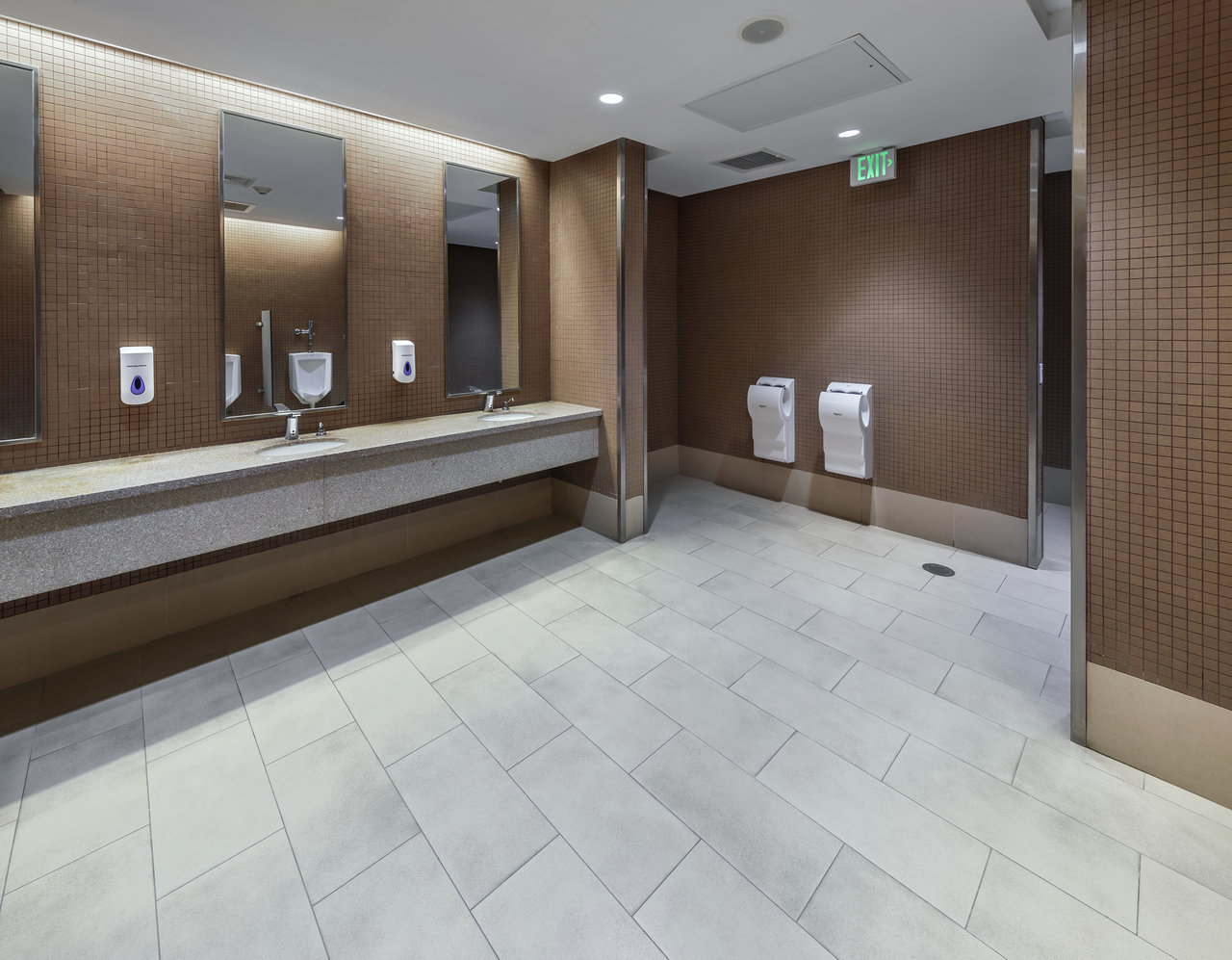 Modern bathroom with light grey floor tiles and brown mosaic wall tiles.