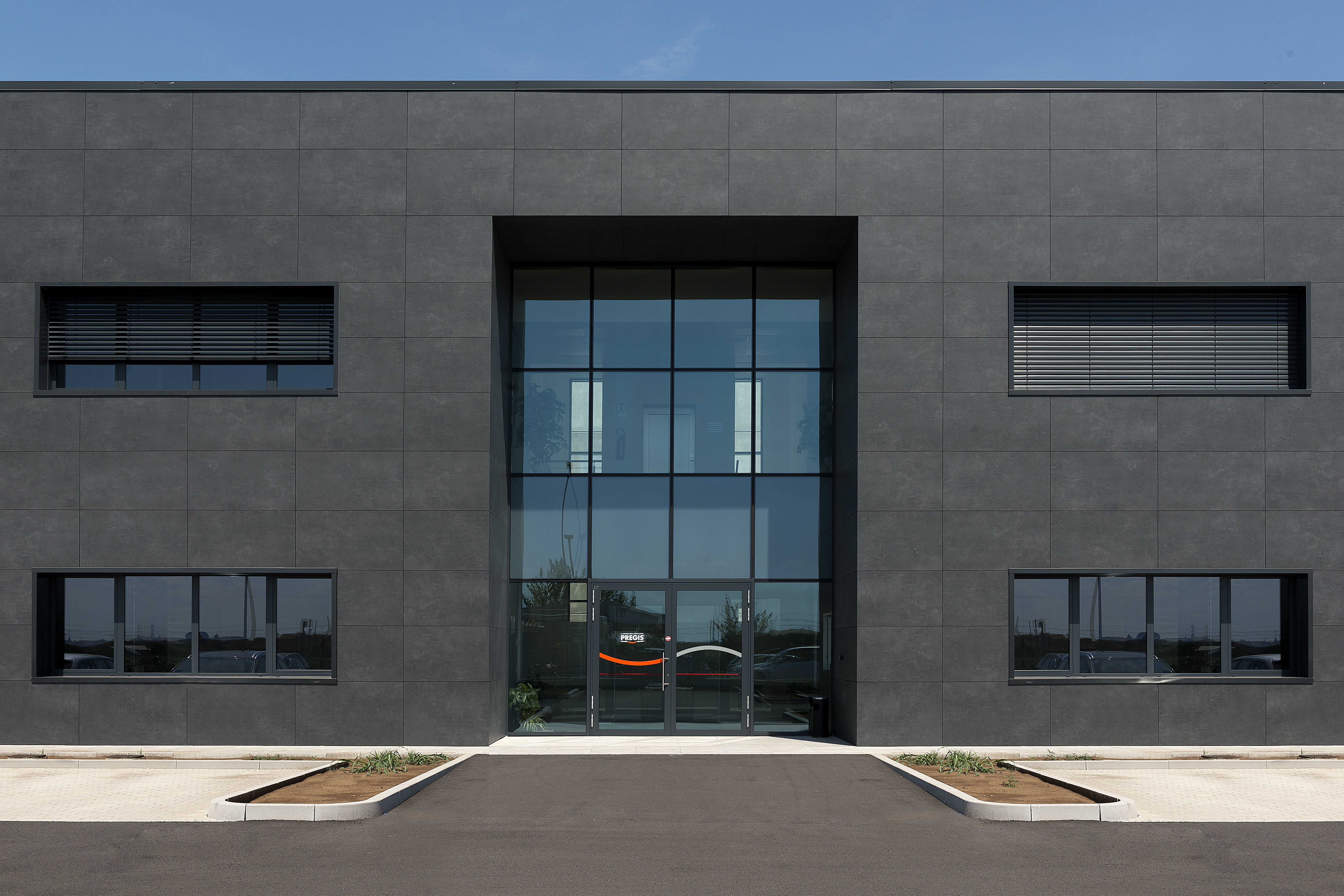 Modern building facade featuring large, dark porcelain exterior tiles for premium cladding.