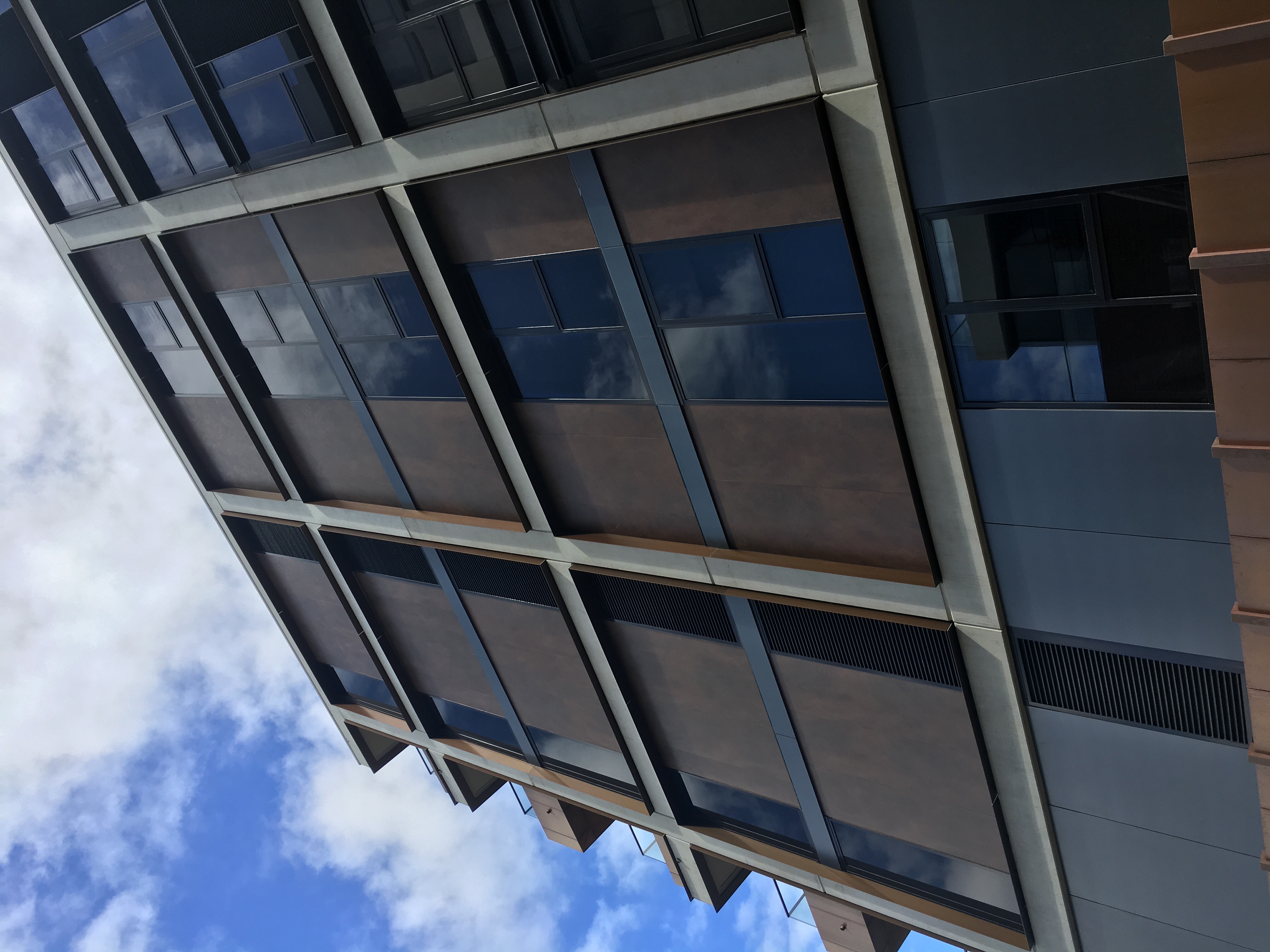 Modern architecture with large-format rust-effect tiles on the facade.