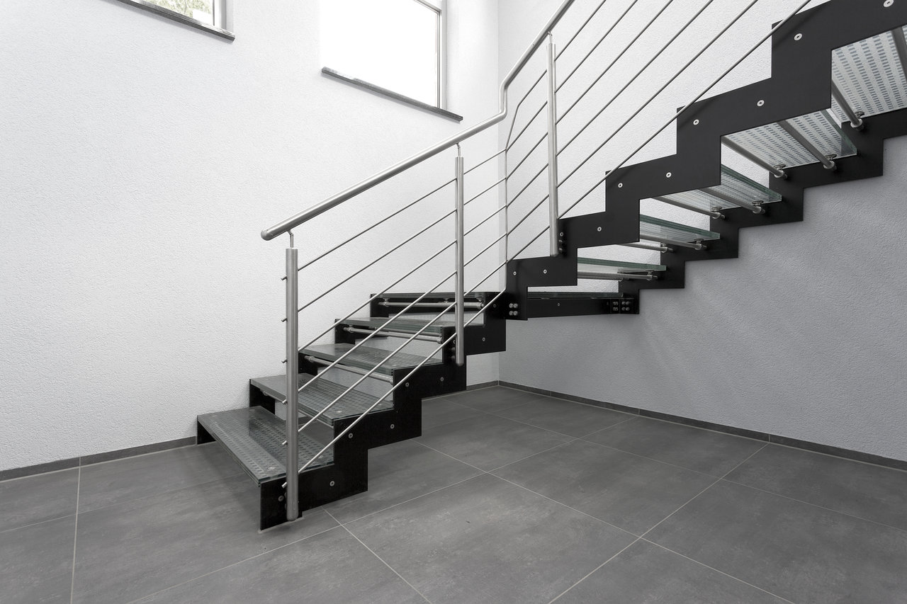 Large-format grey tiles in a modern staircase.