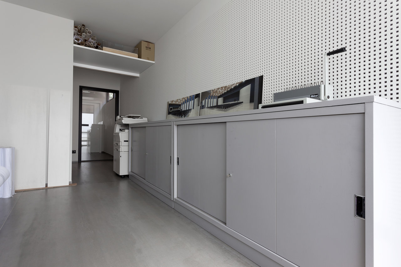 Modern, functional space with large-format light grey tiles.