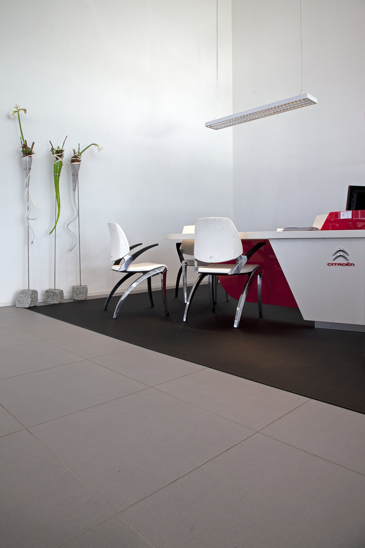 Modern office and reception area with light grey and anthracite tiles.