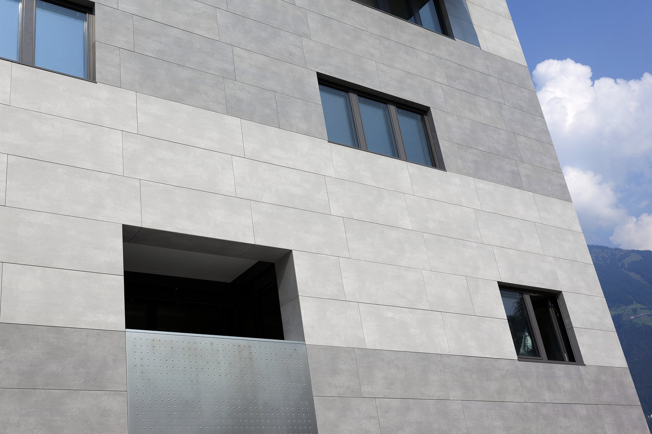Modern building facade featuring two-tone grey tiles.