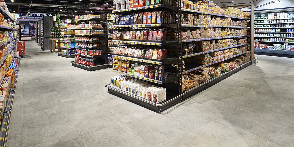 Light concrete-look tile floor in a supermarket.