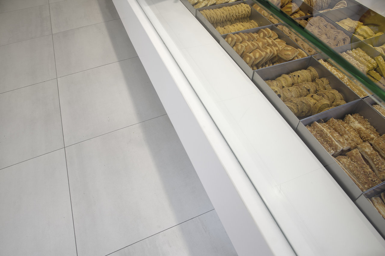 Timeless, light grey floor tiles with fine texture for stylish living areas.