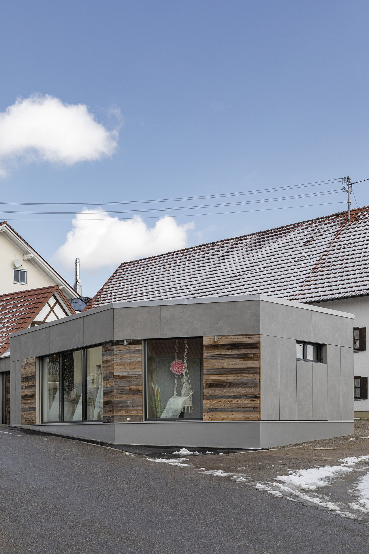 Modern building with grey facade and wood cladding, inspired for tile projects.