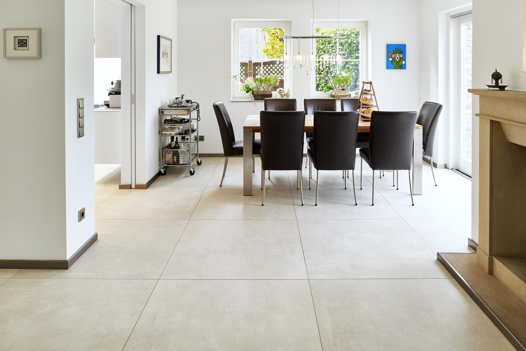 Modern, light porcelain stoneware tiles in living and dining areas.