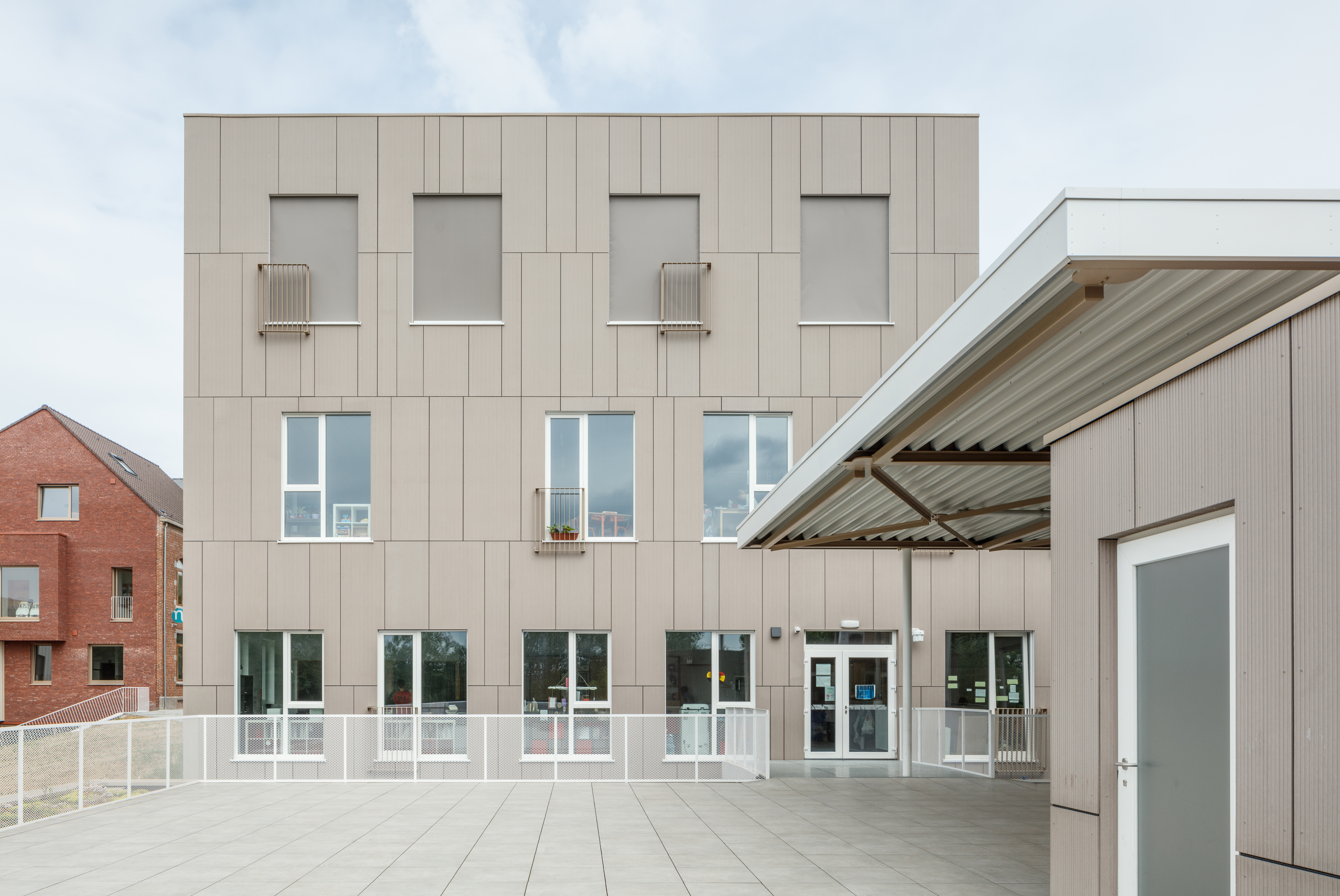 Light beige patio slabs in front of a modern building.