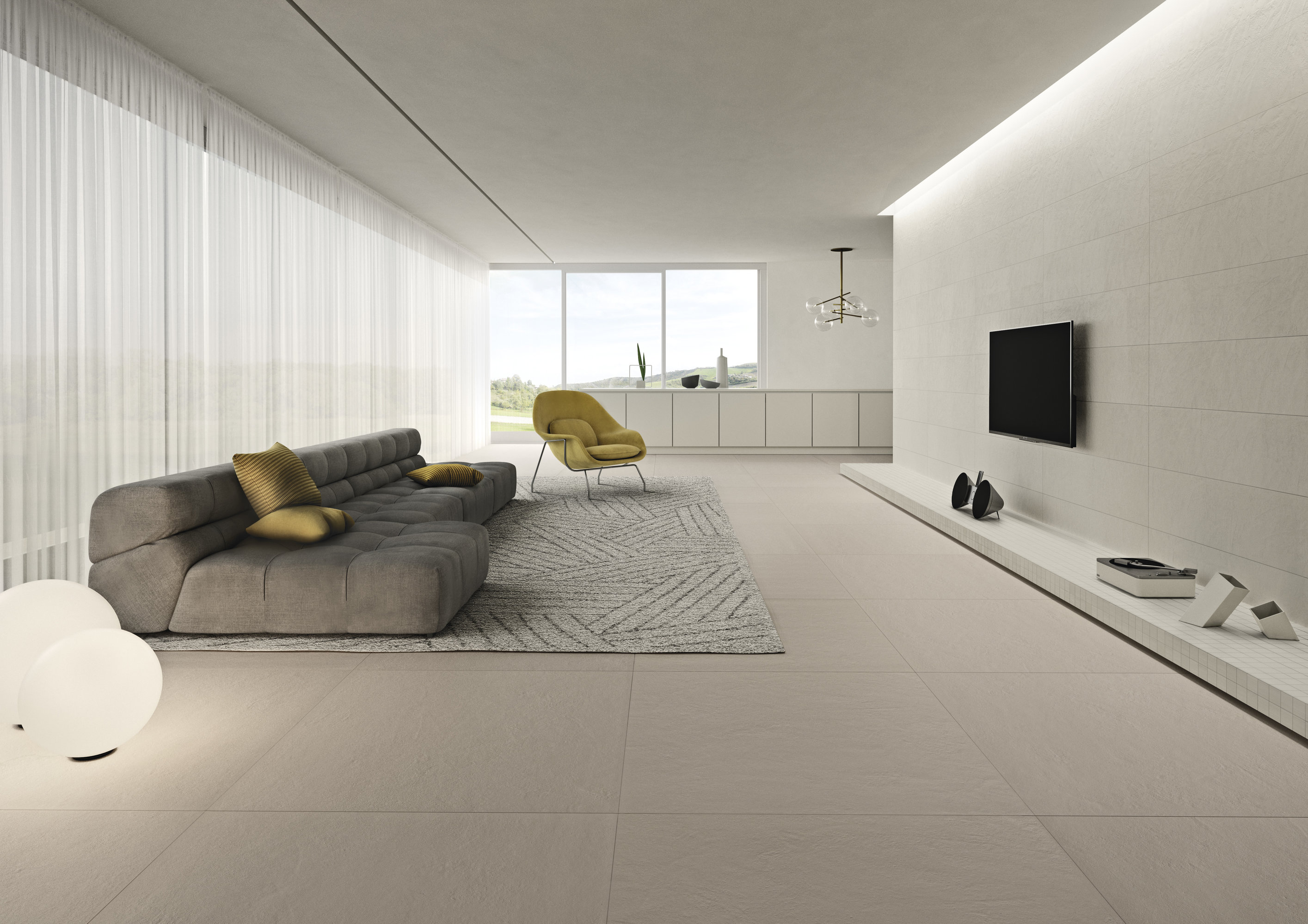 Modern living room with light Porcelaingres tiles and minimalist decor.
