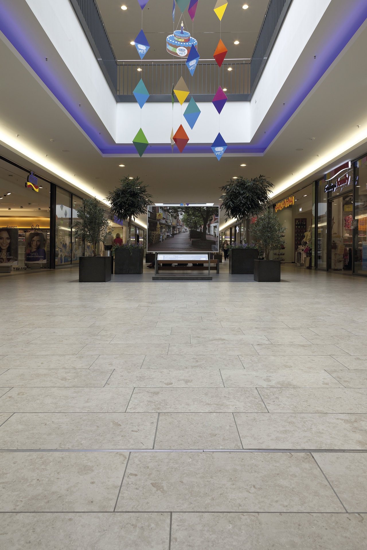 Light, large-format indoor floor tiles for modern commercial spaces.