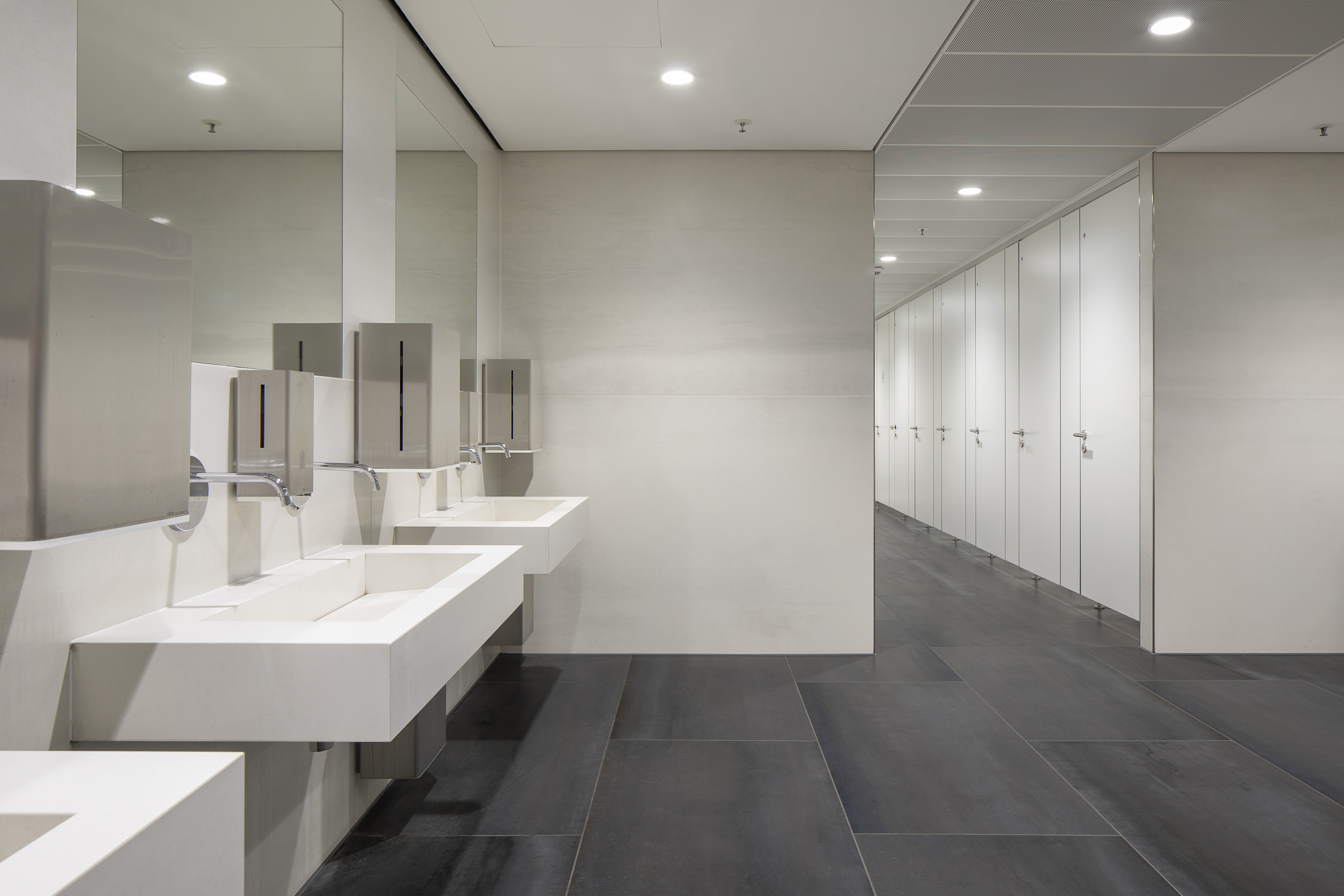 High-quality dark grey concrete-effect floor tiles in a modern bathroom.