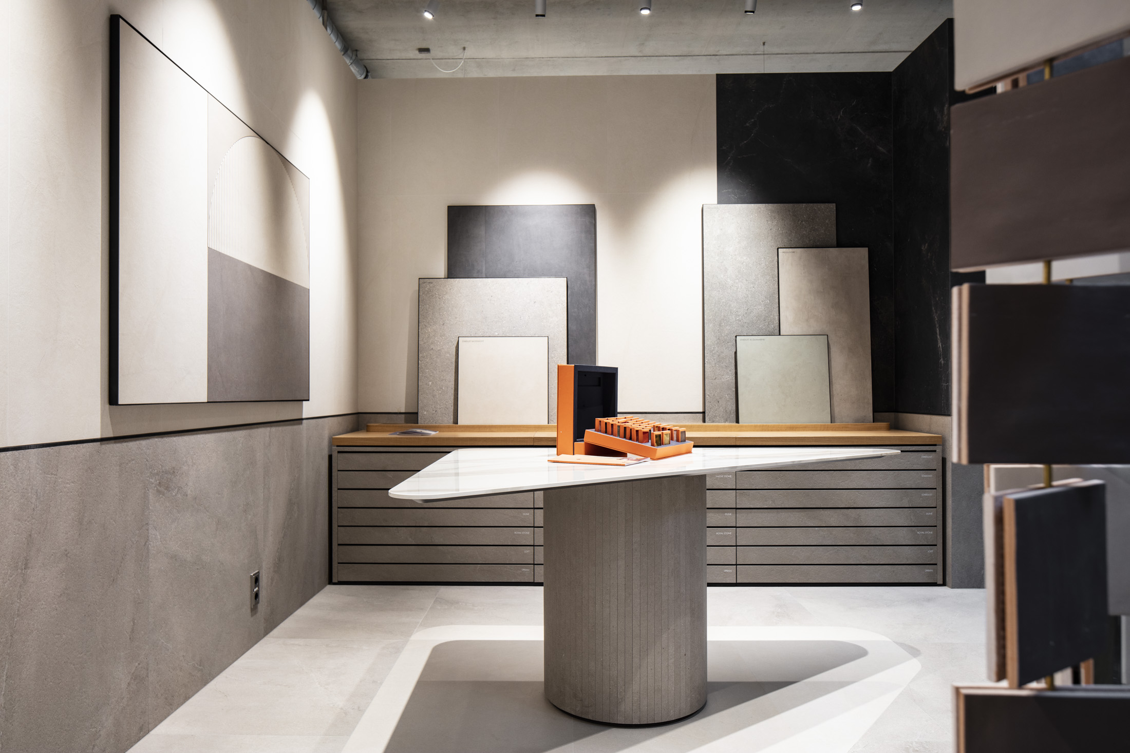 Display of premium Porcelaingres and Schöner Wohnen tiles in a modern showroom.
