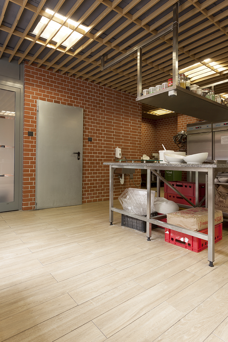 Light wood-effect floor tiles in a modern interior.